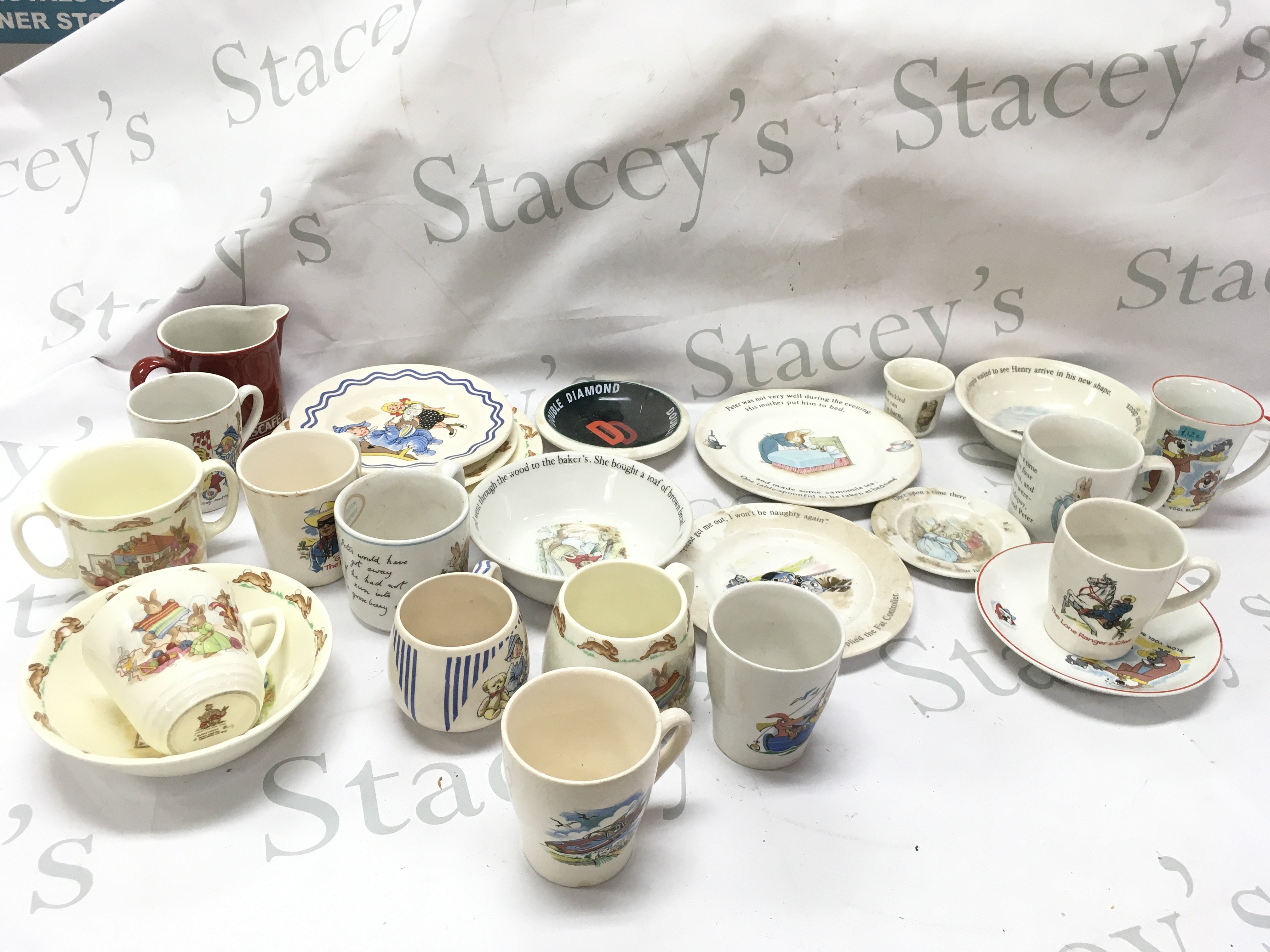 A collection of vintage children's ceramic cups and saucers including The Lone ranger KSP England , Andy Pandy Royal Norfolk , Peter rabbit and Beatrix potter Wedgwood, Huckleberry Hound Ridgwood pottery,