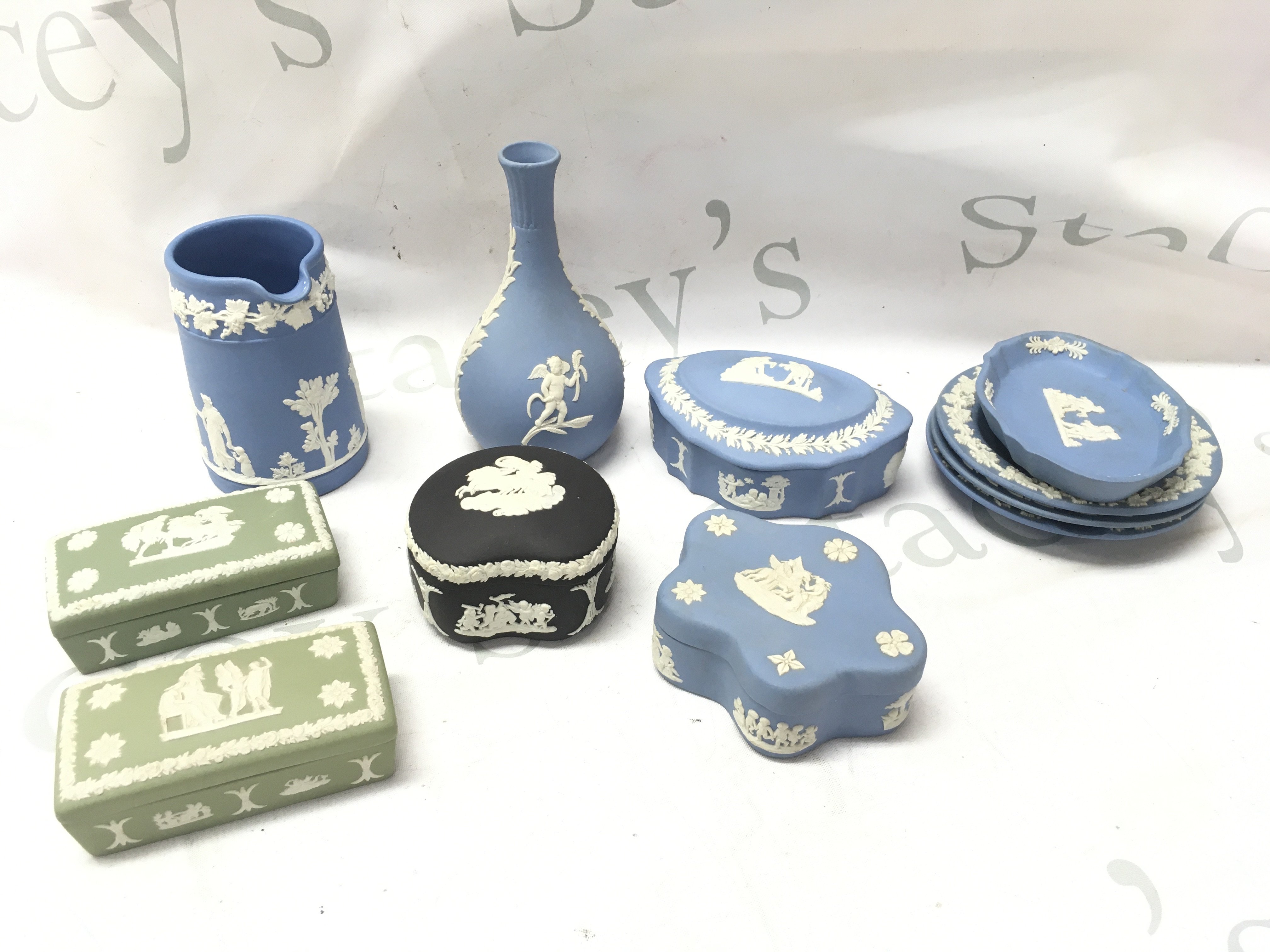 A collection of various Wedgwood Jasper ware including a vase, trinket boxes, dishes . This lot cannot be posted