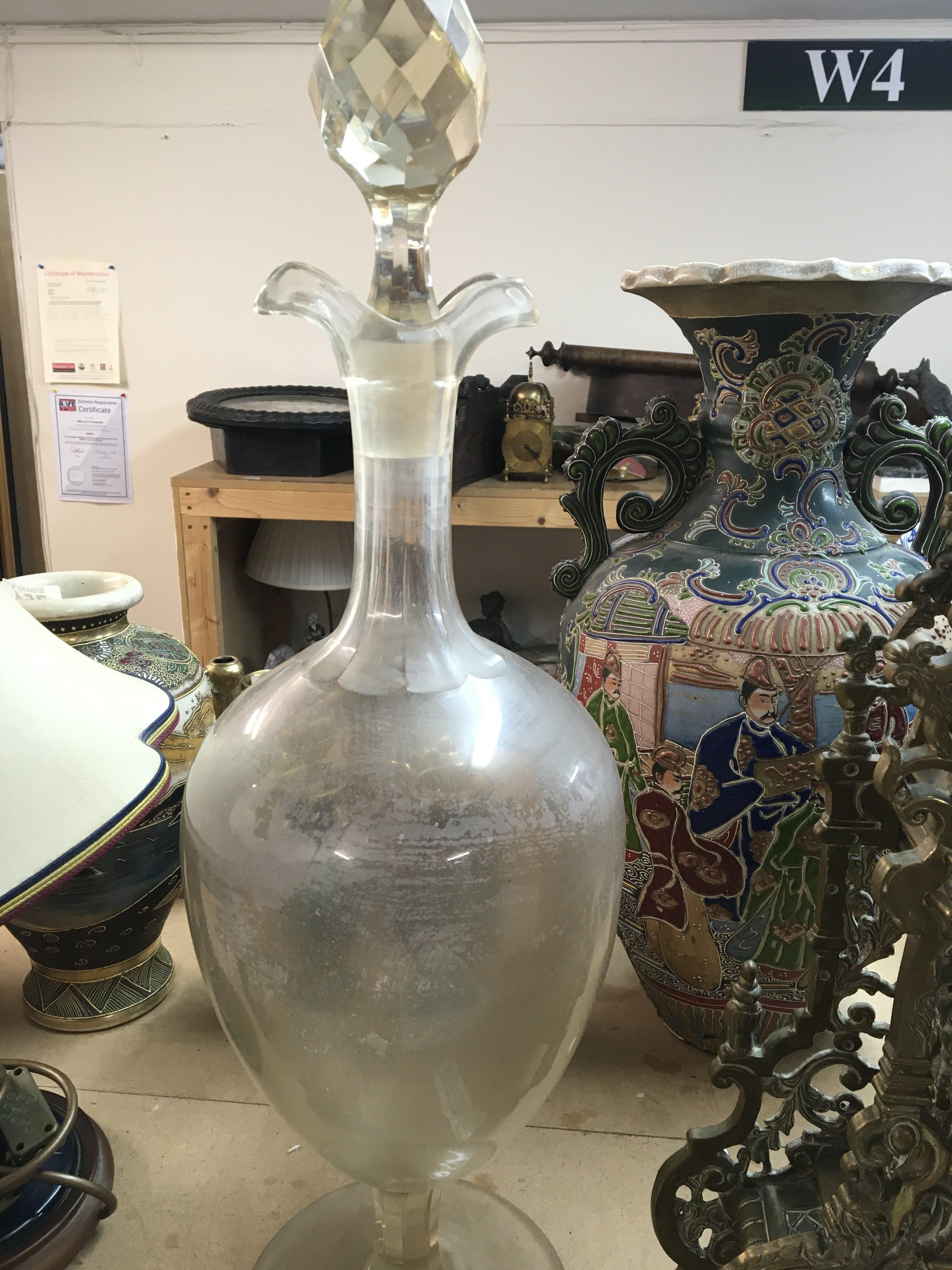 A apothecary decanter with detachable stomper .