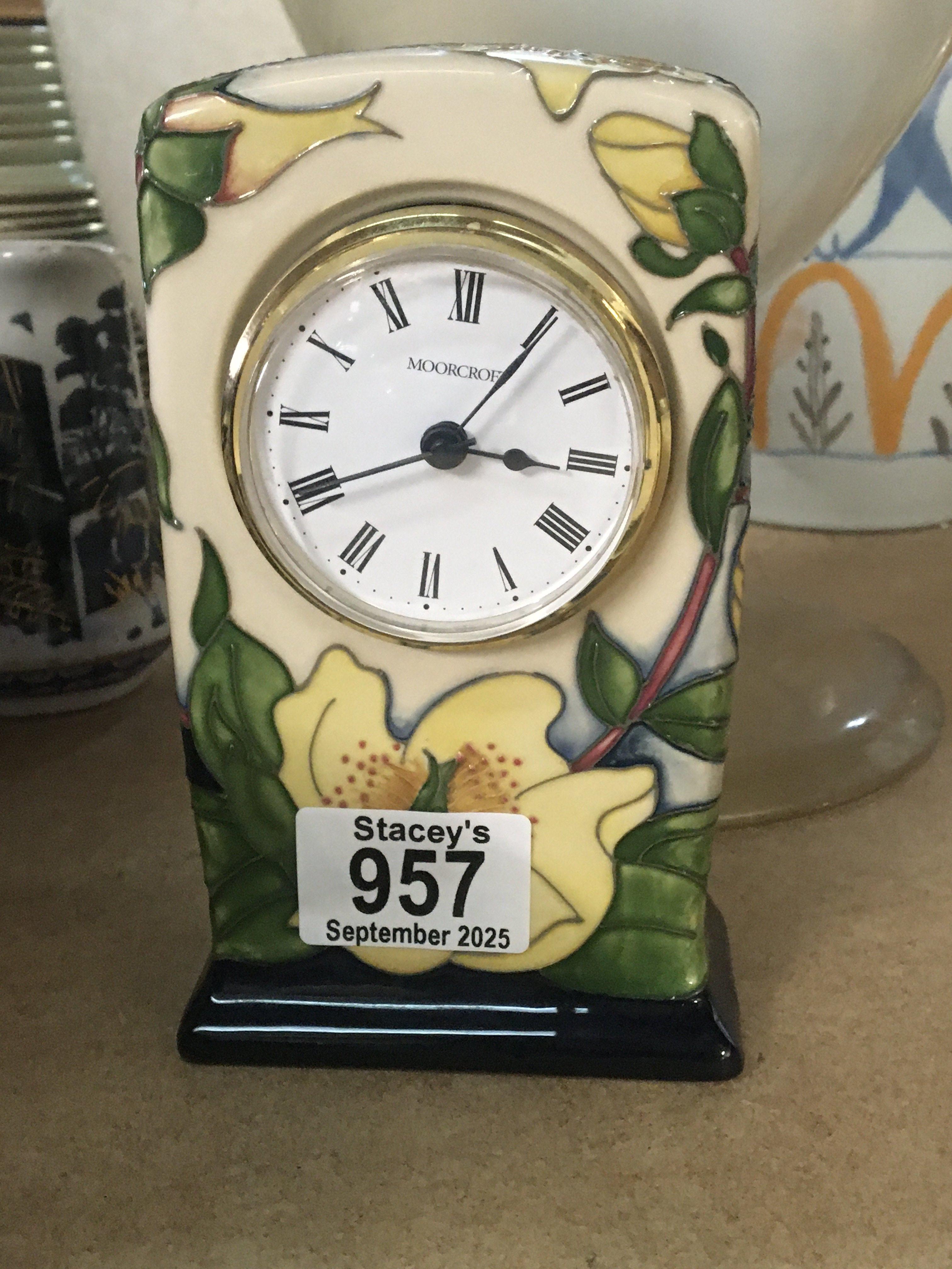 A Moorcroft clock decorated with floral design.