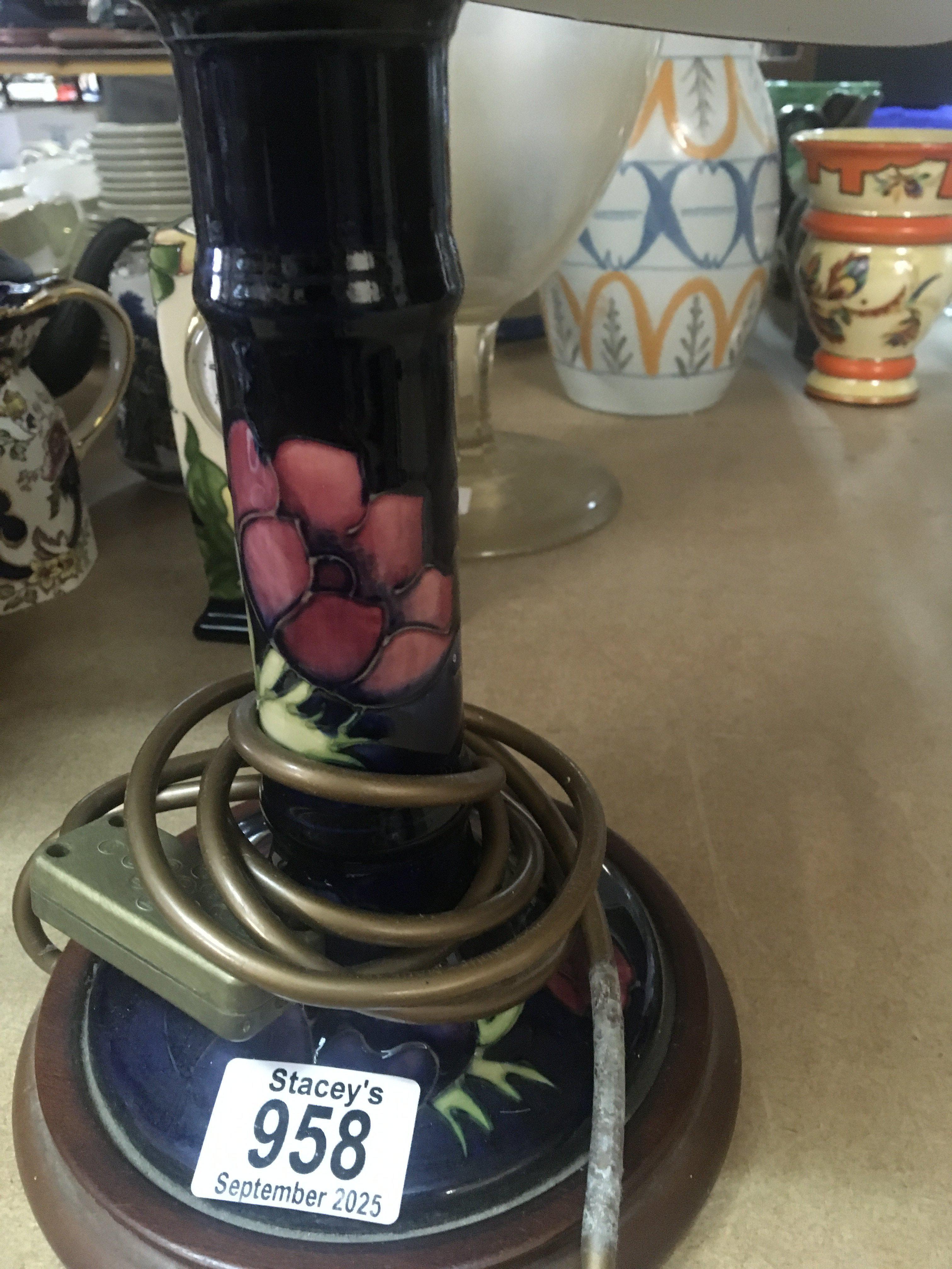 A Moorcroft side lamp decorated with poppies.
