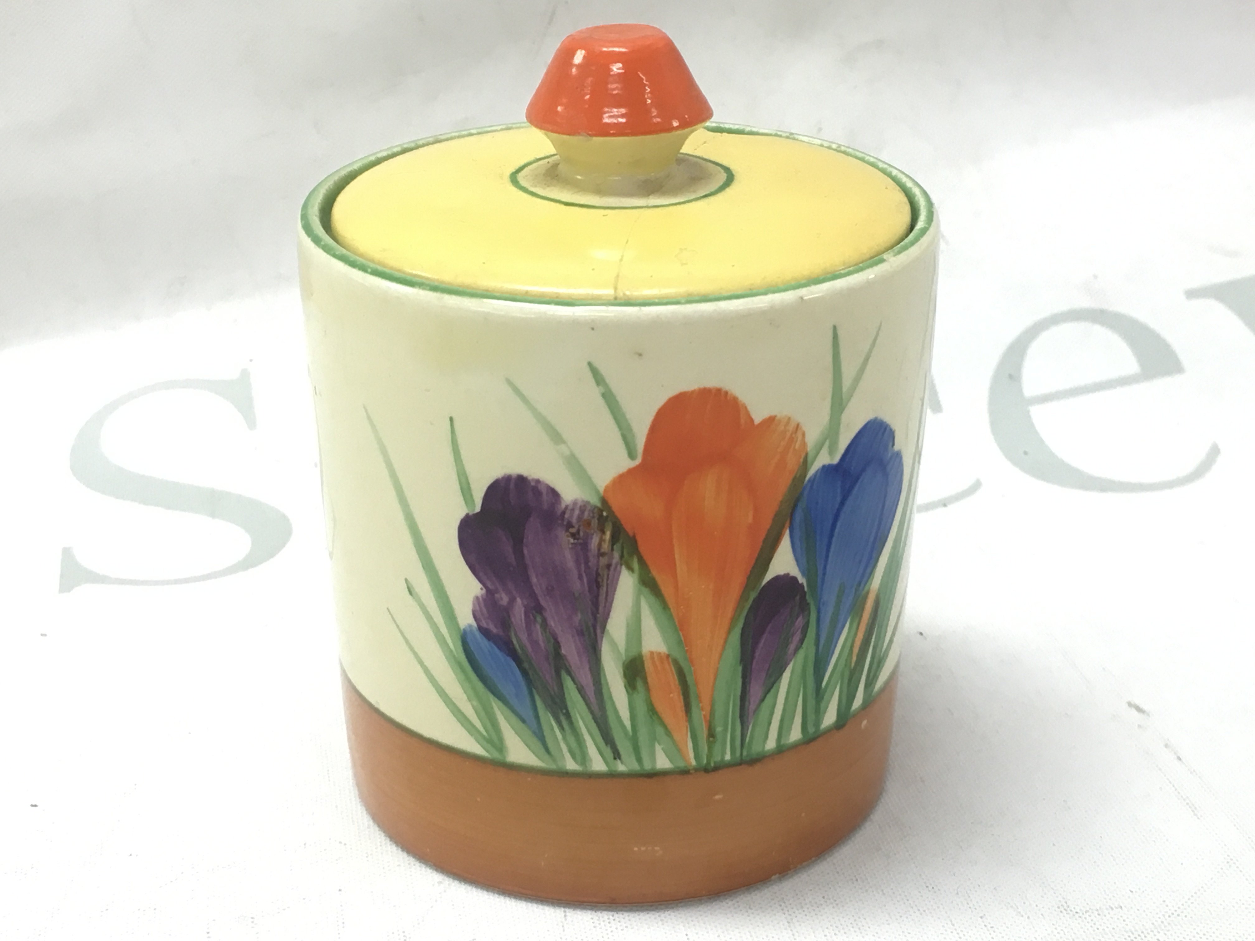 A Clarice Cliff crocus jam pot with a damaged cover