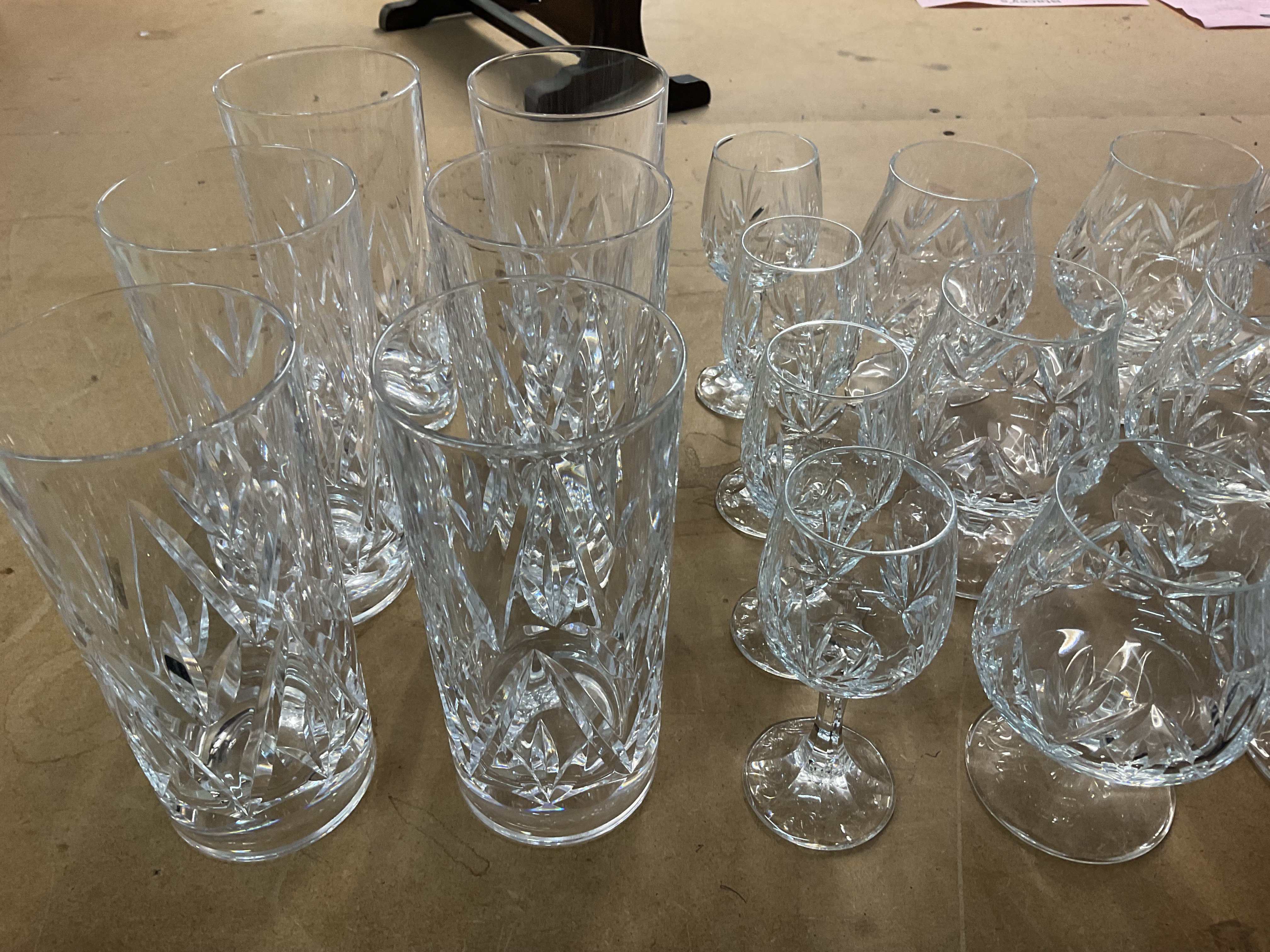 A varied collection of cut glass drinking glasses. (D)