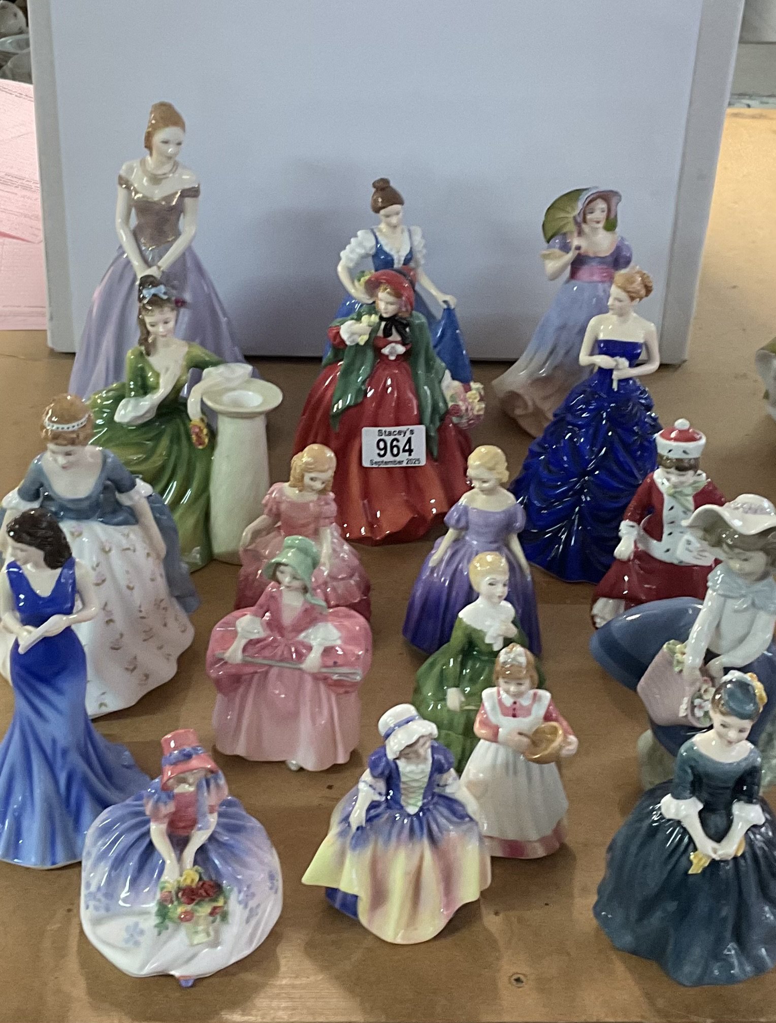 A large collection of porcelain and girl lady figurines to include Royal Doulton, Lladro, Royal Worcester, Adderley.