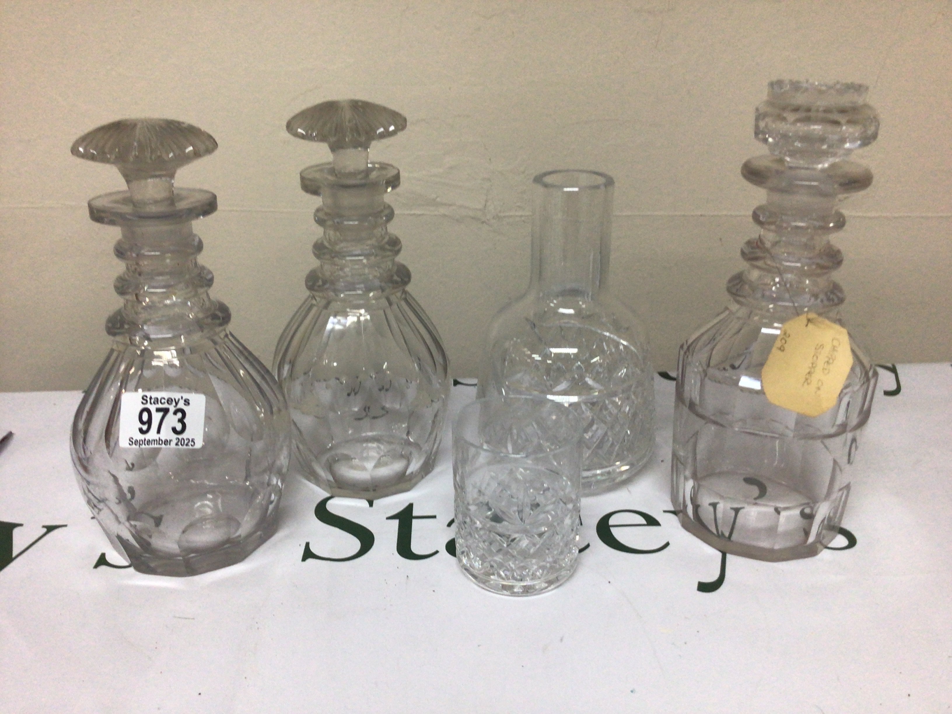 A pair of Victorian cut glass decanters with mushroom stoppers one other decanter and a glass carafe.