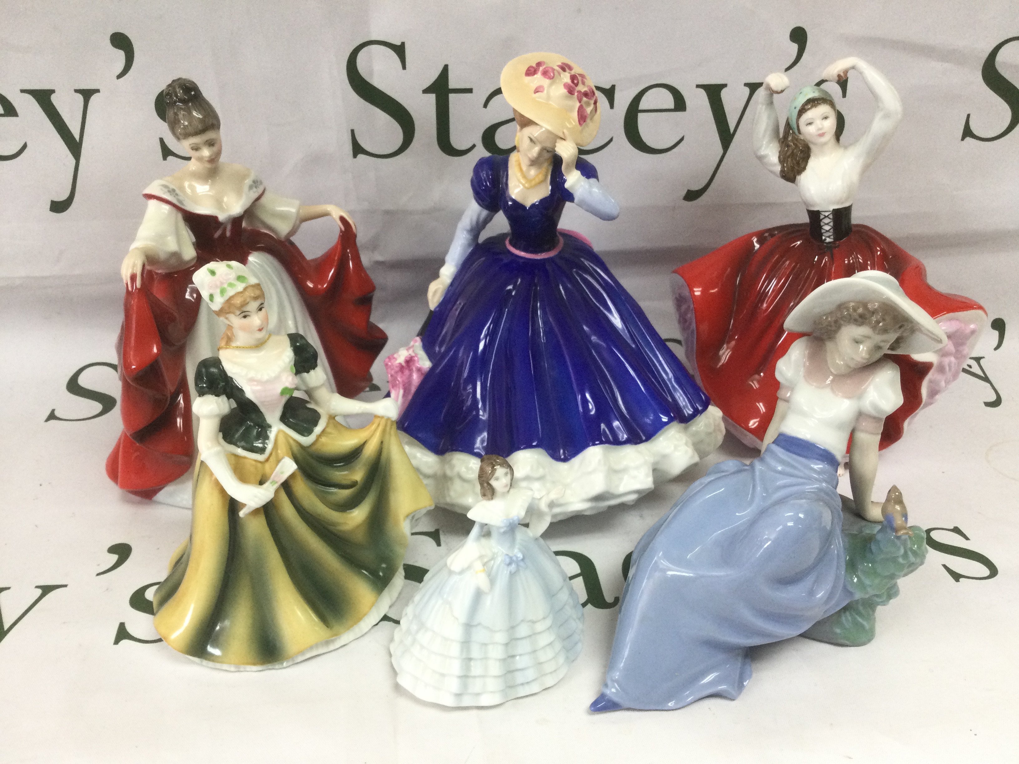 A collection of mainly Royal Doulton figures of ladies. Shipping category D.
