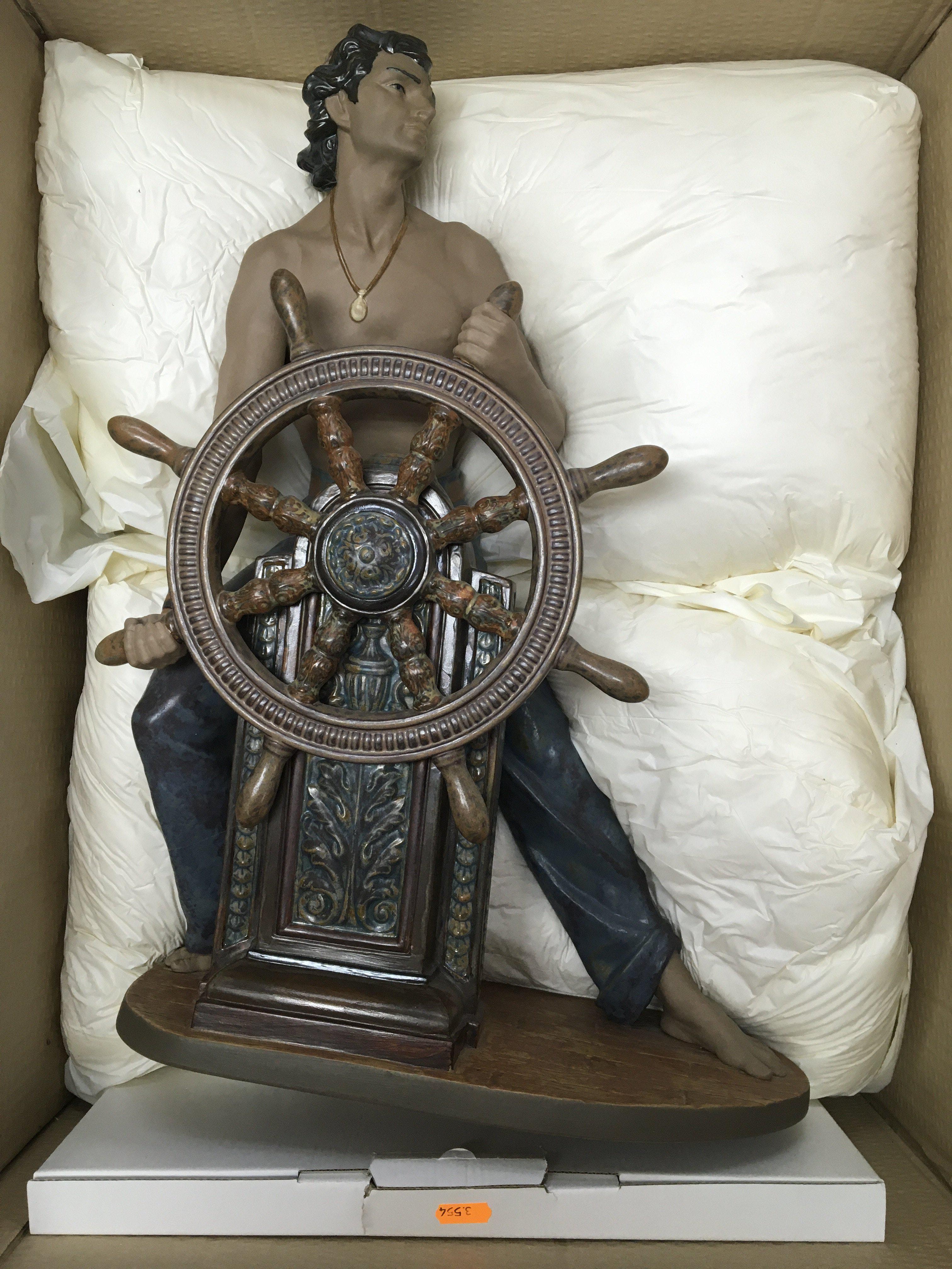 A very large boxed Lladro figure of a sailor at the ships wheel. No obvious damage or restoration, base included. 55cm in height approximately.
