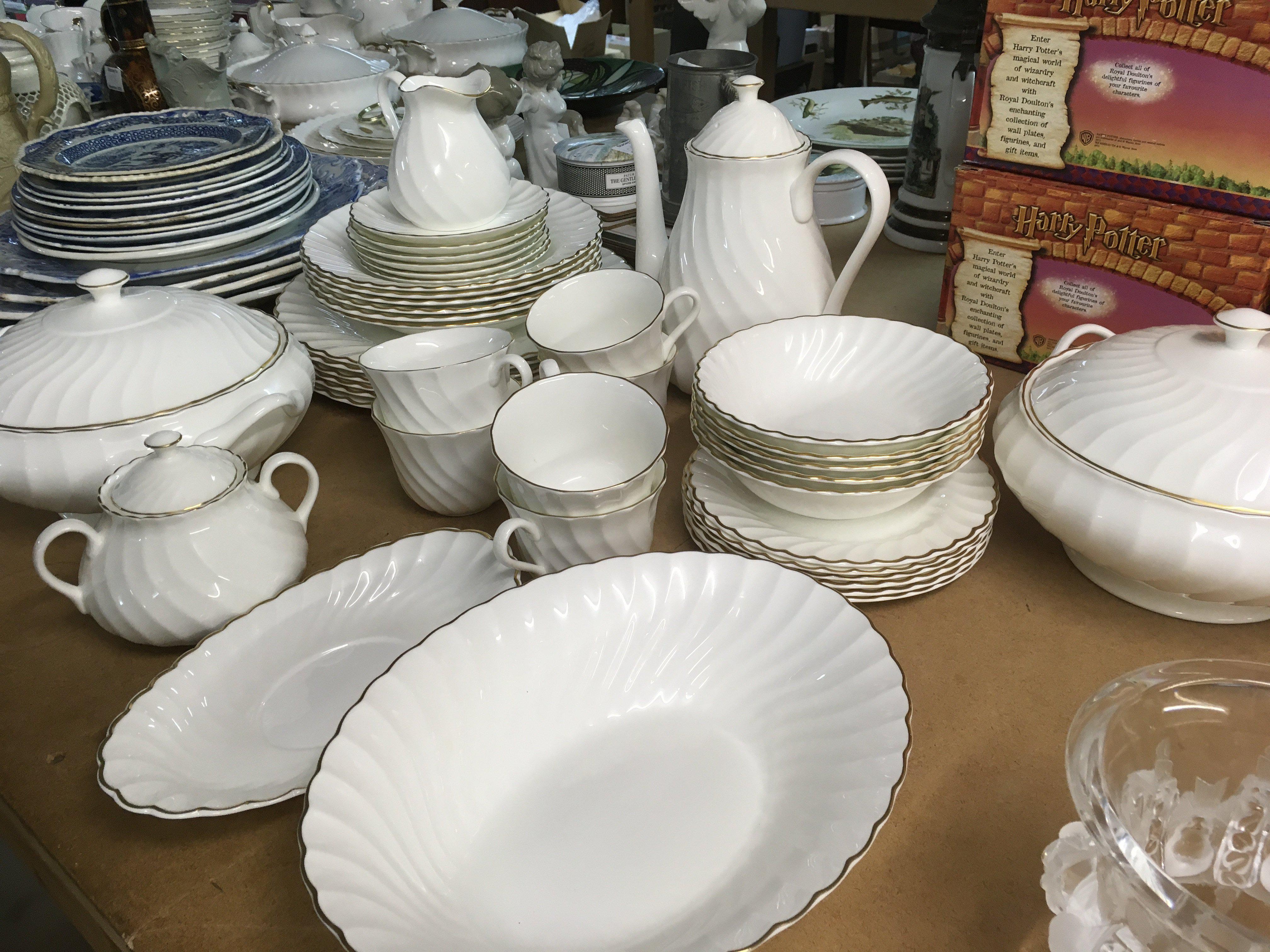 A Wedgwood gold Chelsea service including coffe pot cups saucers and serving dishes.