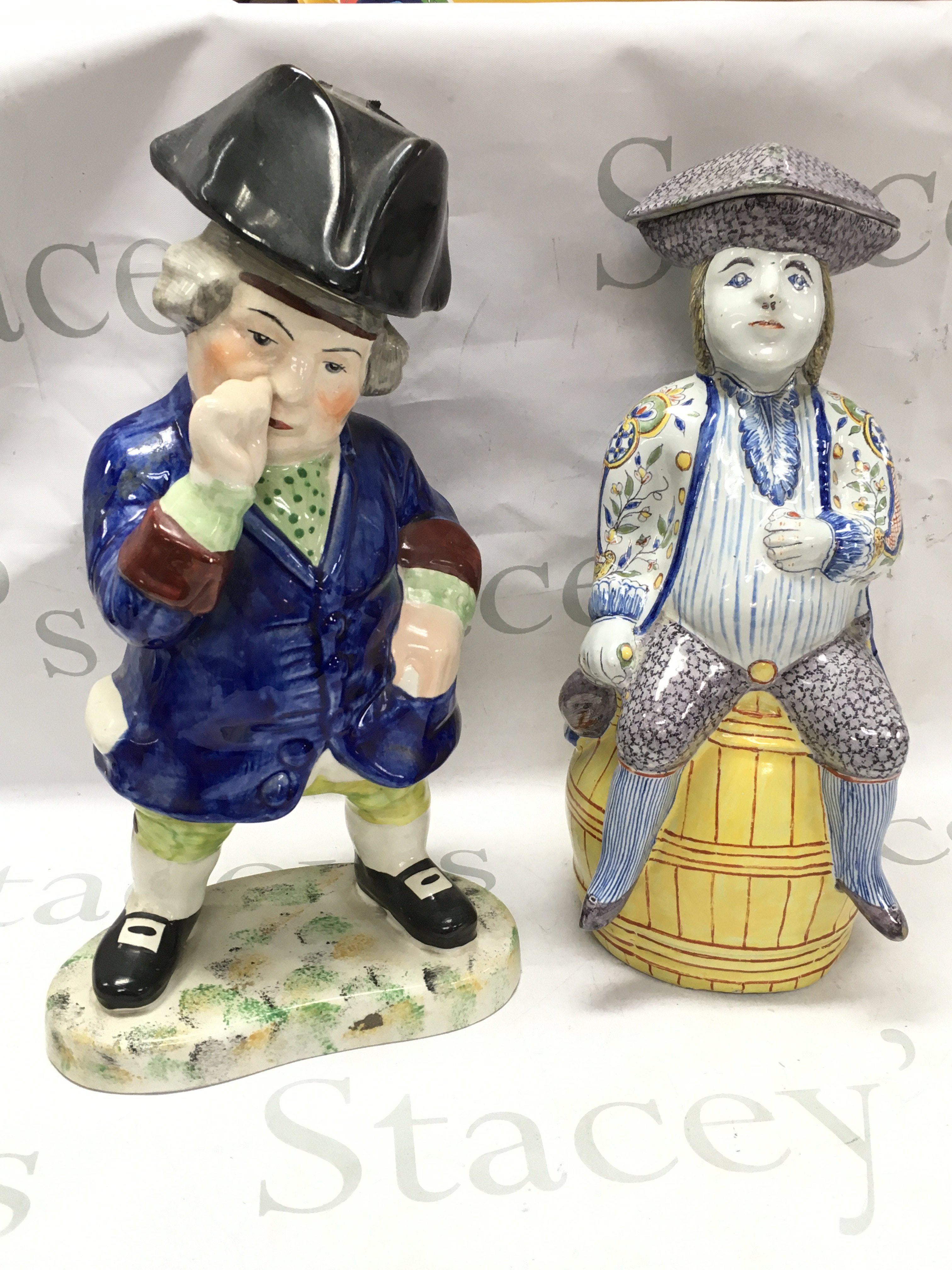 Porcelain Staffordshire Toby figure and a French faience "Jacquot" jug, 33cm tall. This lot cannot be posted