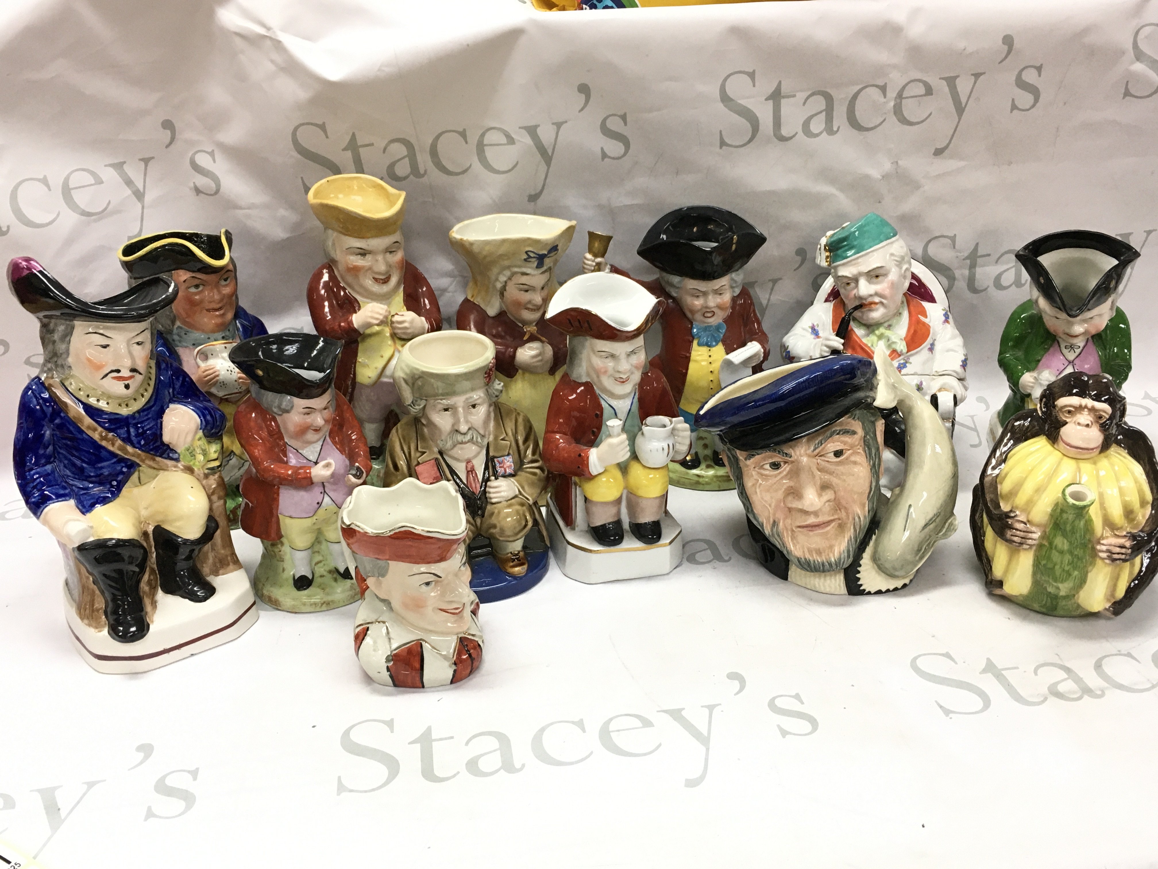 A collection of ceramic Toby jugs , a ceramic tobacco jar of a man smoking a pipe, monkey tea jug etc. this lot cannot be posted