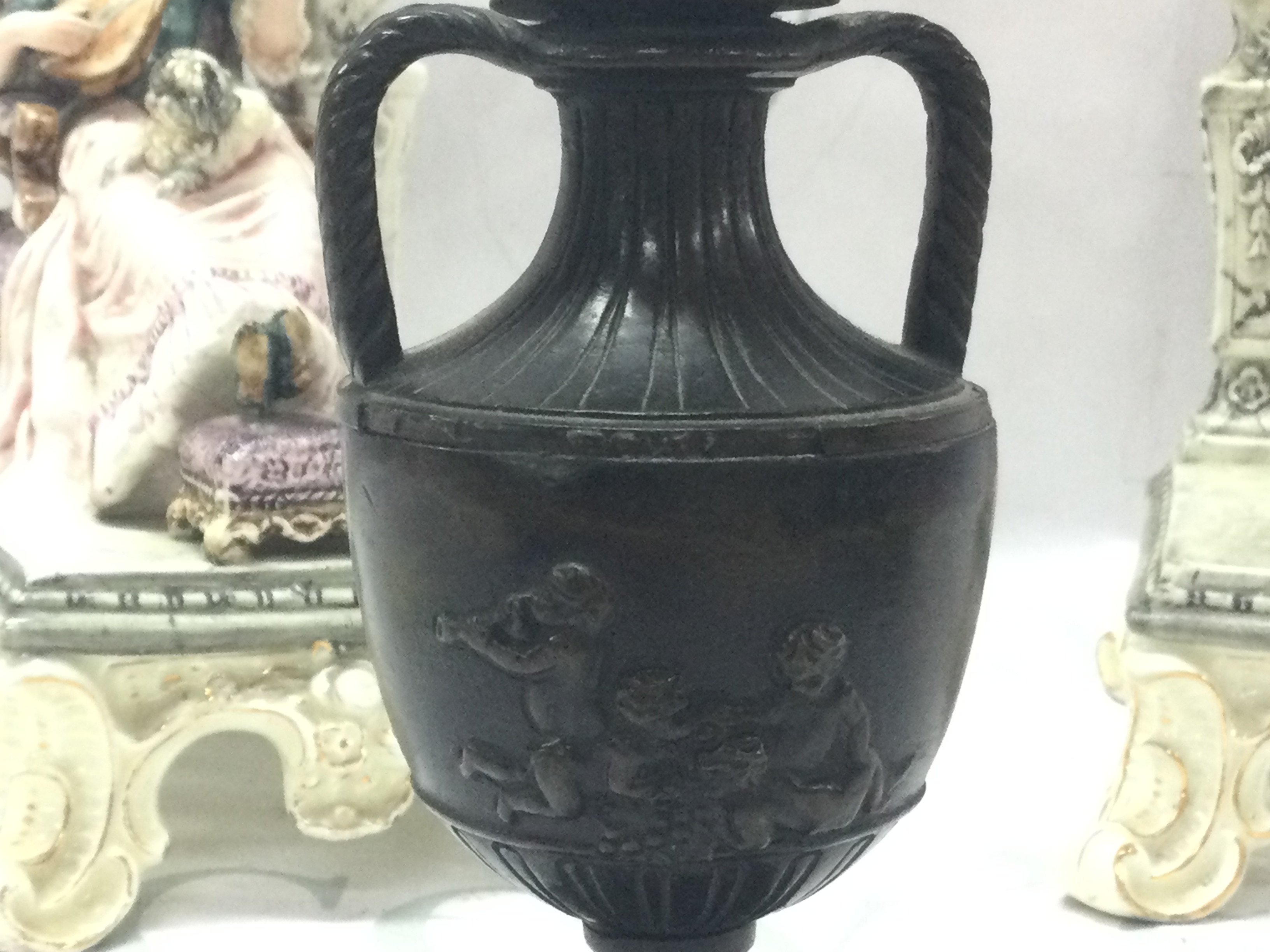 A pair of classical style seated couple figures (20cm tall approx. Damaged and restored )and a late 19th century bronze twin handled vase with putti scene decoration, 13cm tall. This lot cannot be posted- NO RESERVE