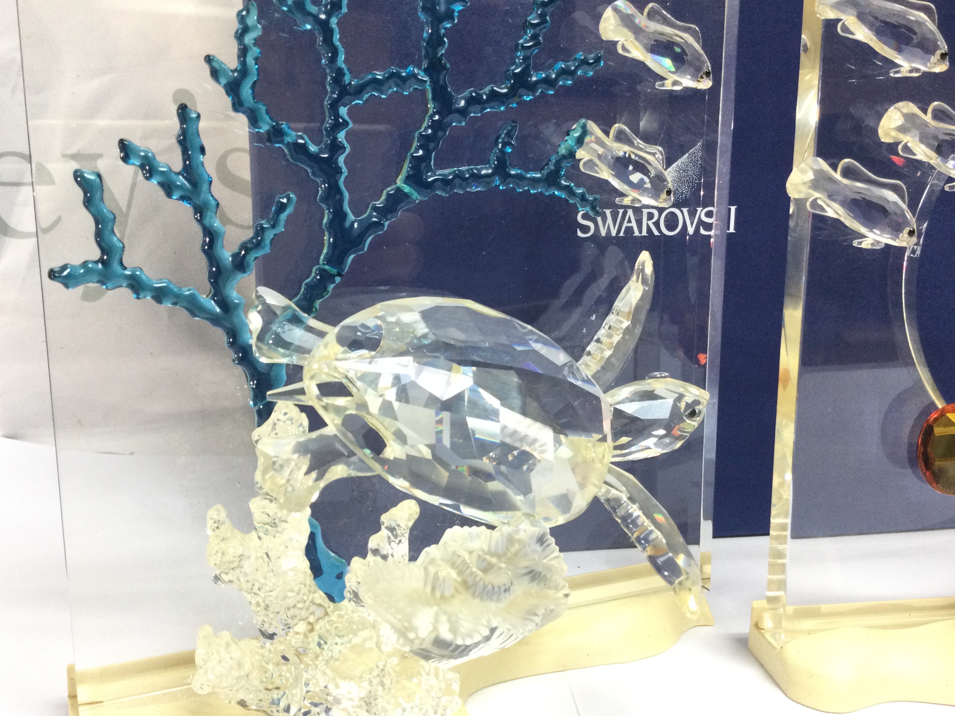 A collection of boxed Swarovski crystal glass Wonders of the Sea figures including turtles, clown fish, angel fish ( Fins need regluing) no back drops. This lot cannot be posted