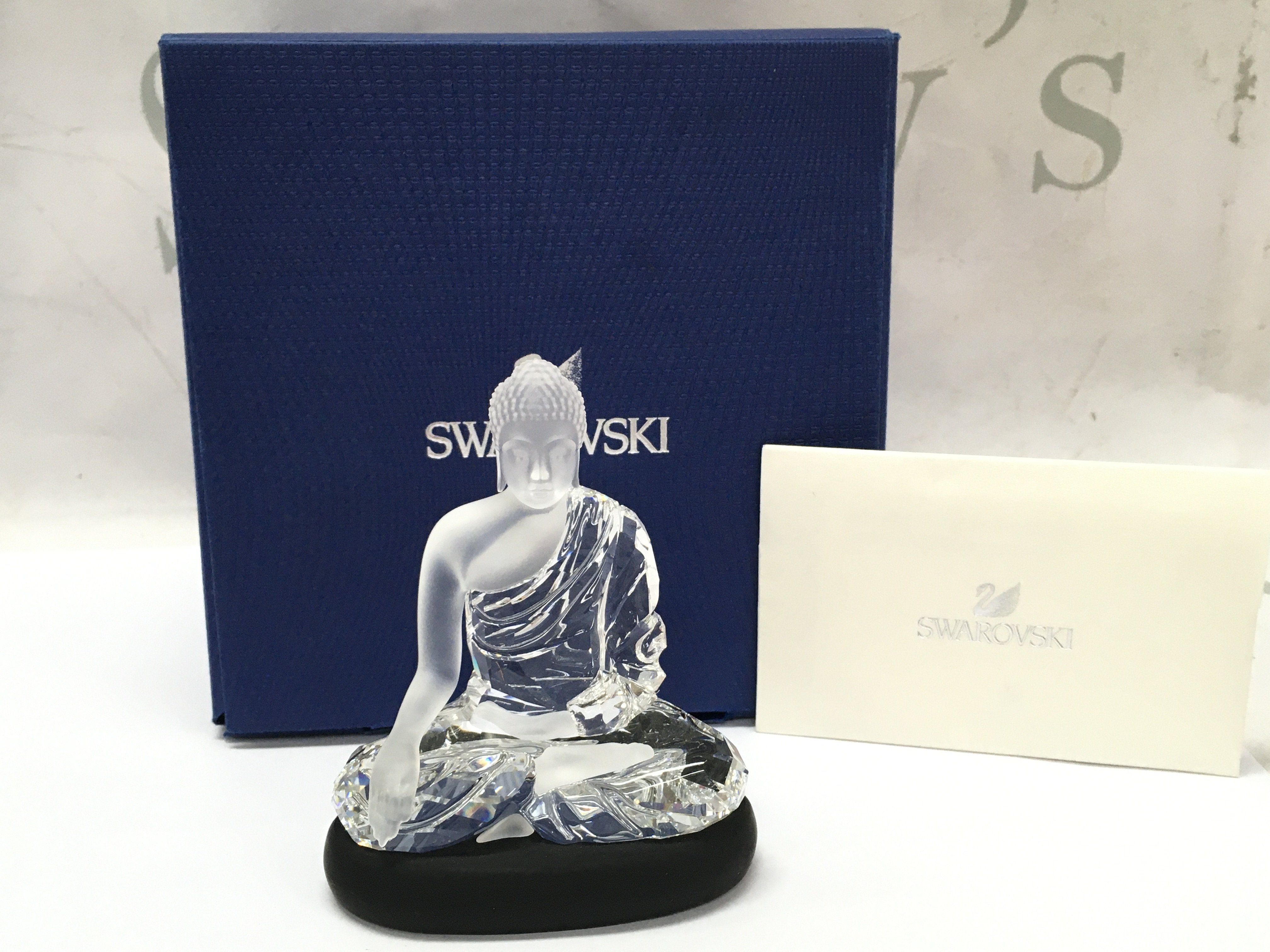 A boxed Swarovski Buddha with stand , 9.5cm tall. Postage category B