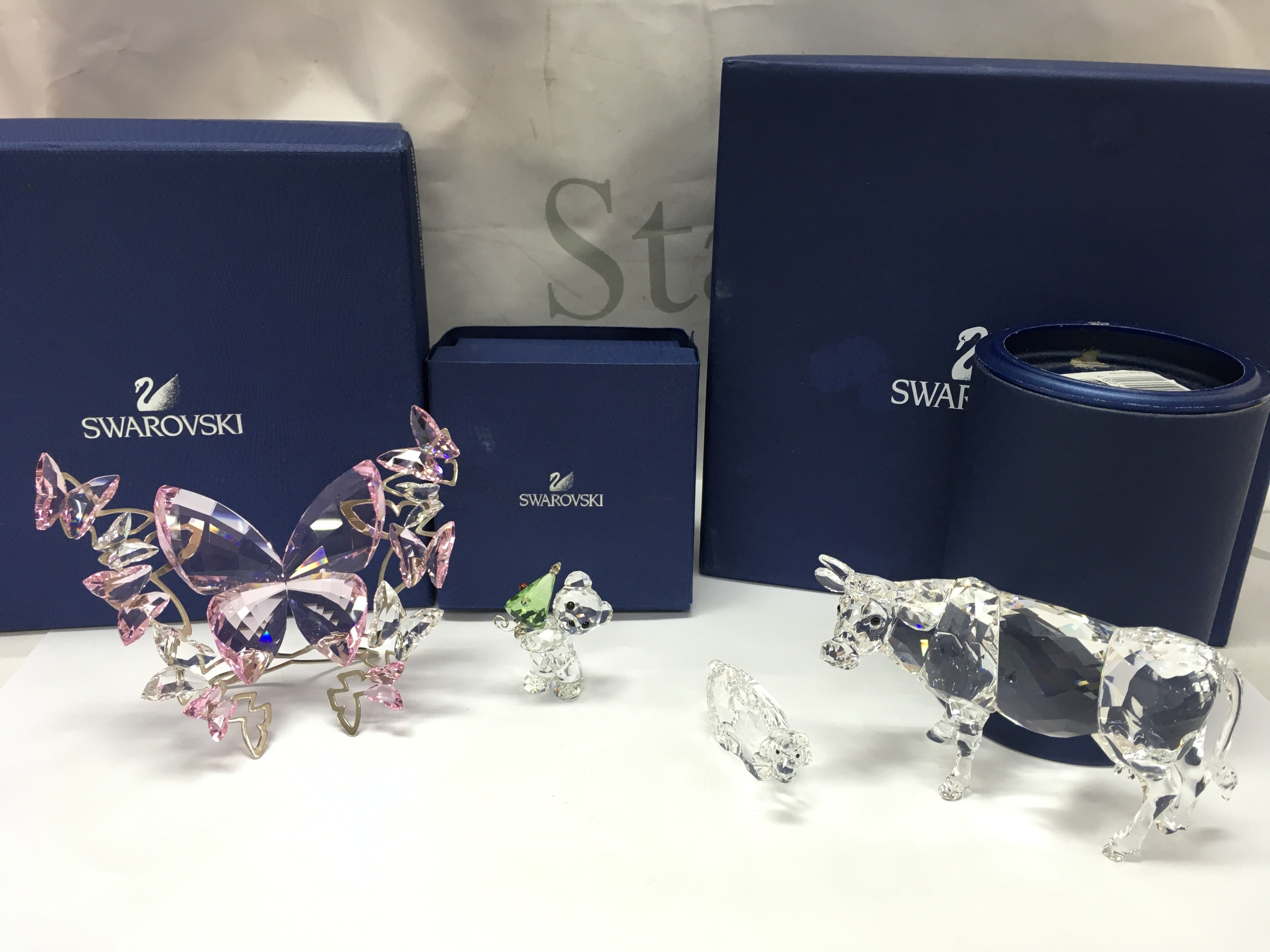 Four boxed Swarovski Crystal items including Kris bear Christmas, Large Rosaline butterfly , Zodiac lion, cow. Postage category B
