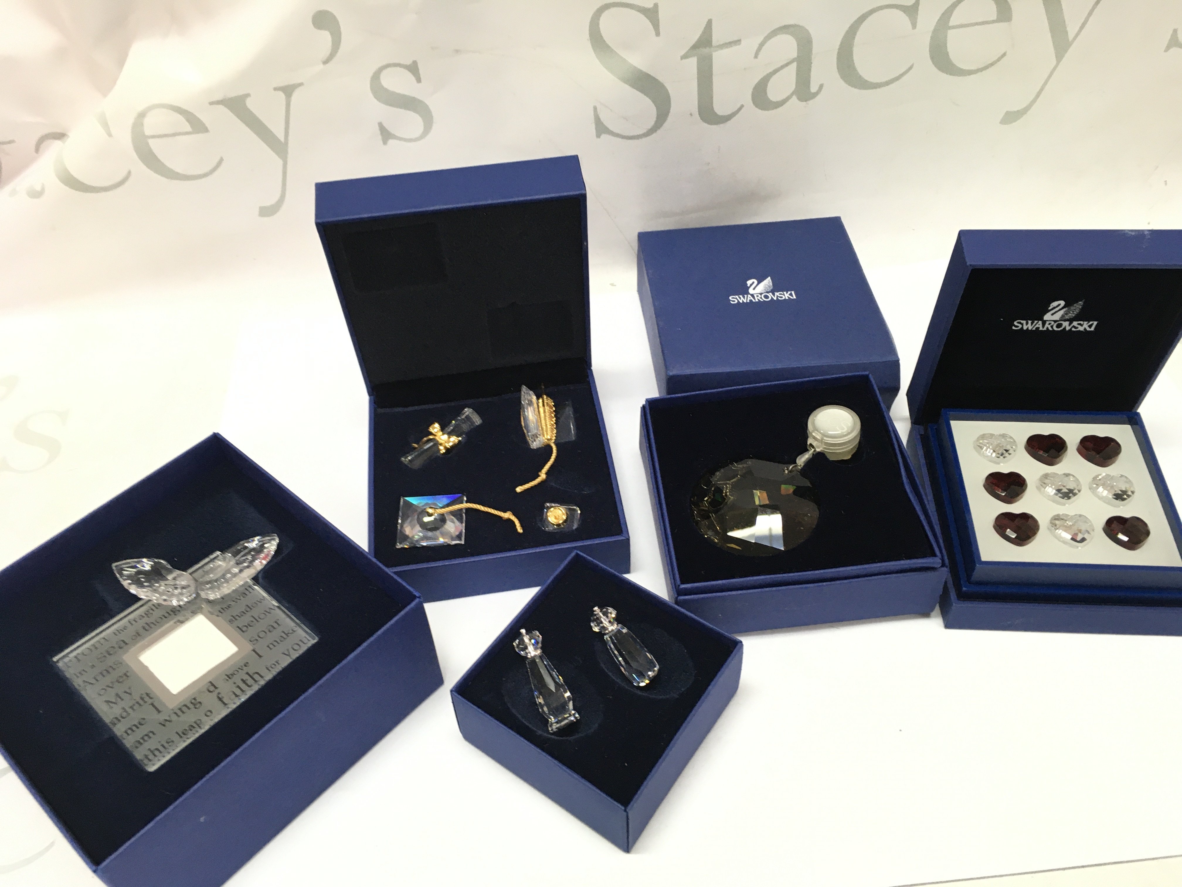 Five Swarovski Crystal items including a cruet set, poetry photo frame , sun catcher , tic tac toe, graduation set. Postage category b