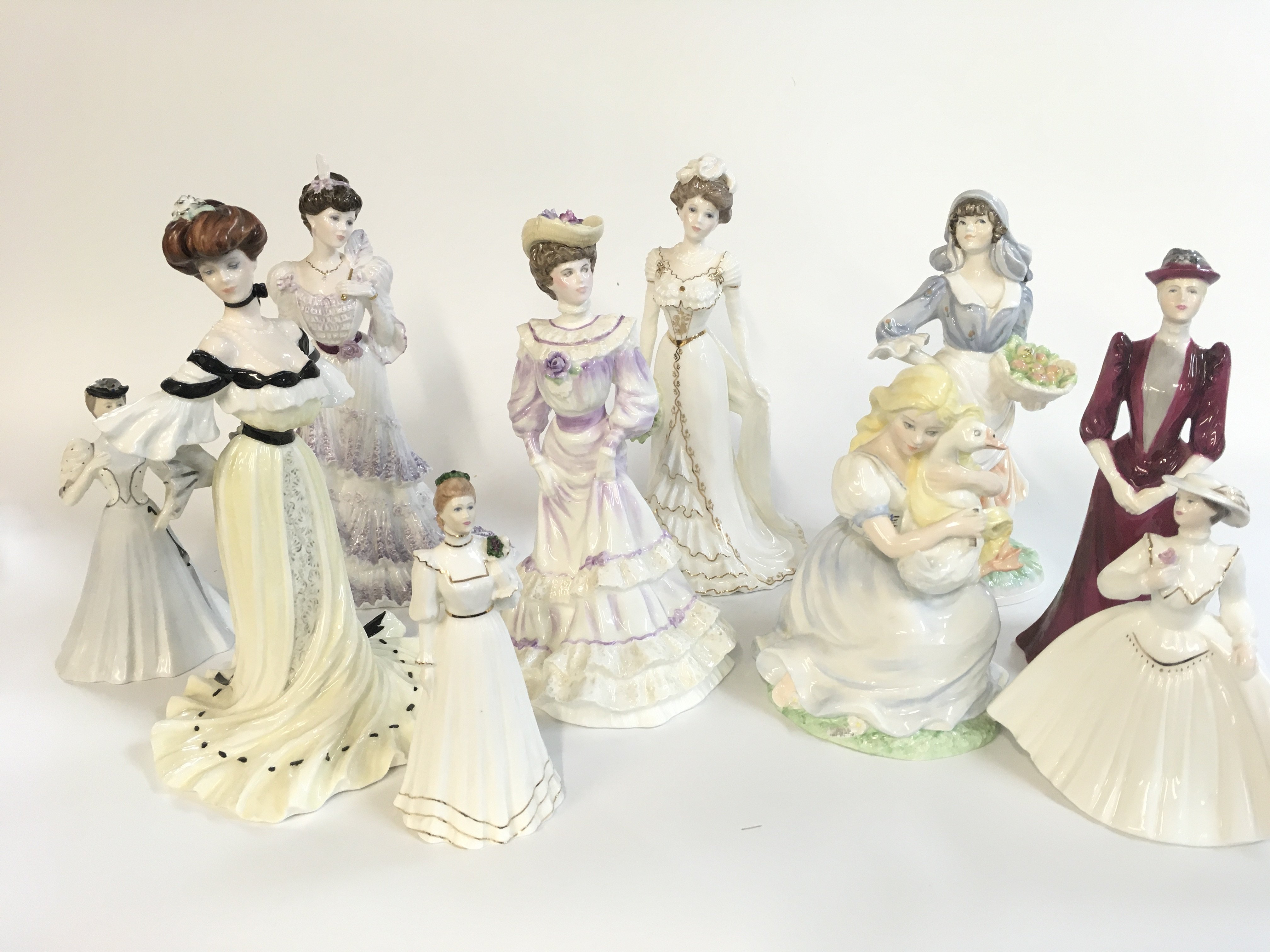 A Collection of porcelain Coalport and Royal Worcester figures . This lot cannot be posted