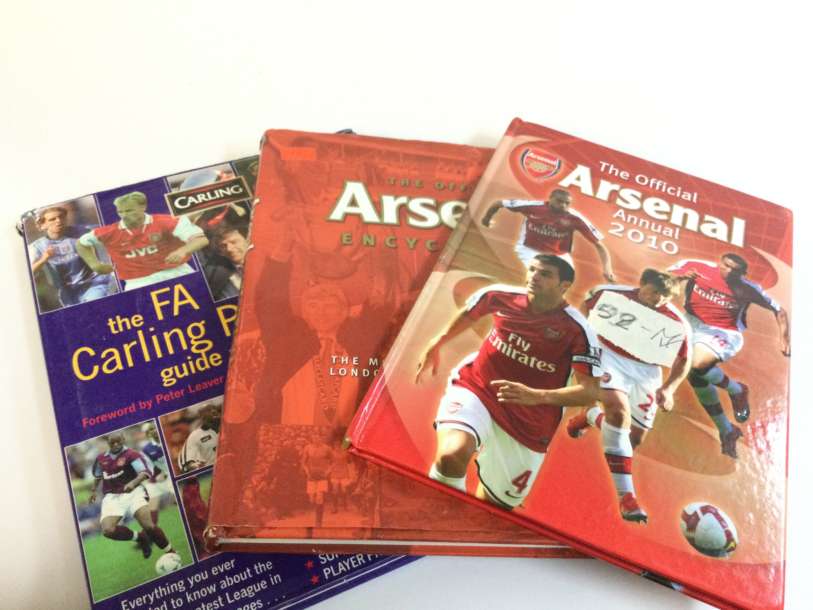 An Arsenal Official annual 2010 book, Arsenal encyclopaedia, the FA carling premiership guide and book of records . No reserve . Postage category B