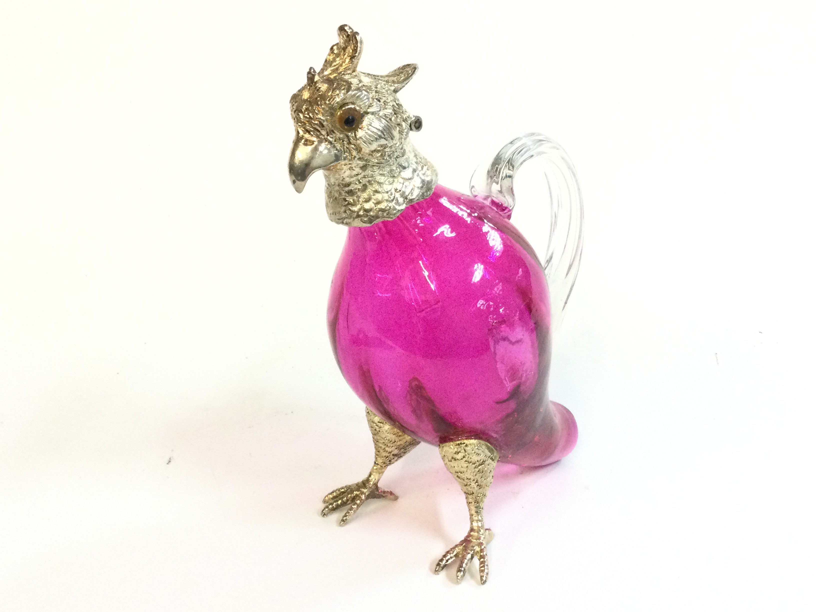 A cranberry glass parrot cockatoo decanter, 17cm tall . This lot cannot be posted