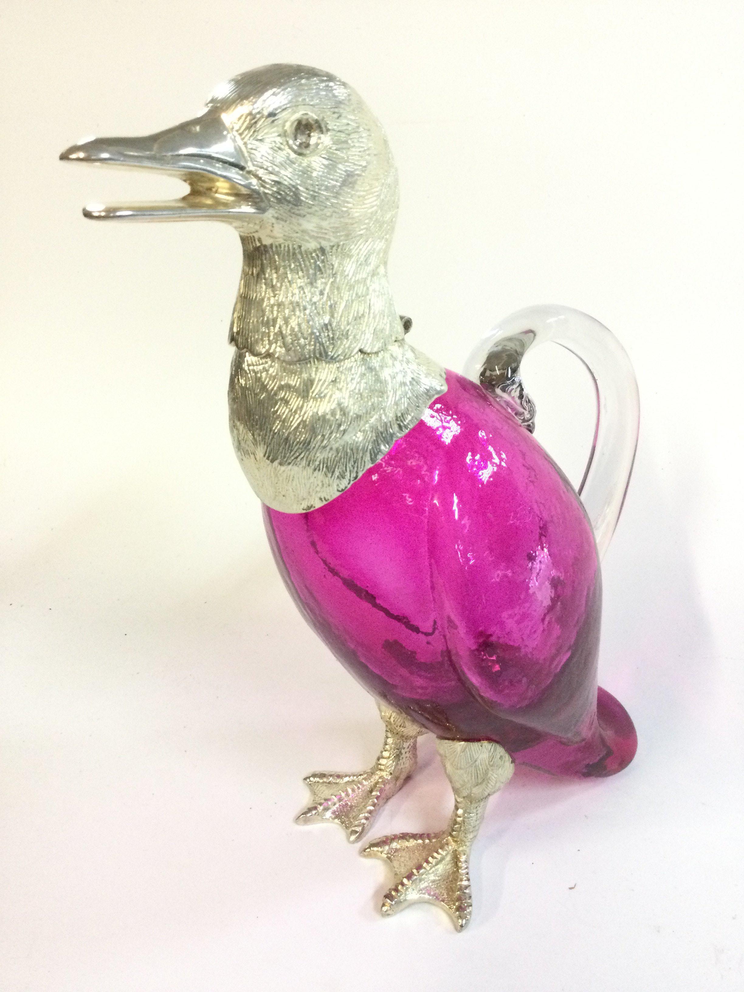 Cranberry glass duck claret jug decanter , 26cm tall .