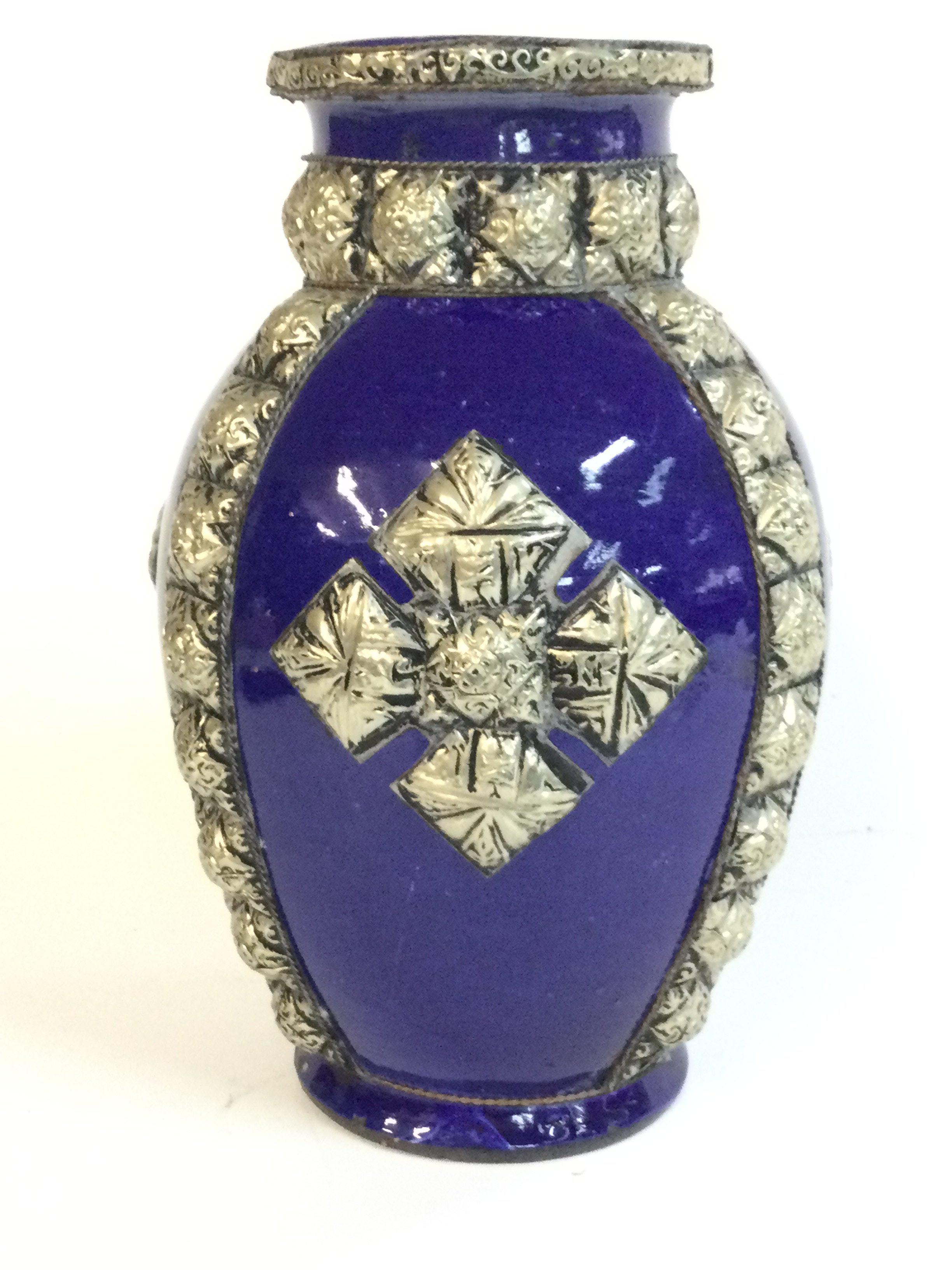 A blue pottery Moroccan 19th century vase encrusted with silver colour Maillechort, 22cm tall.