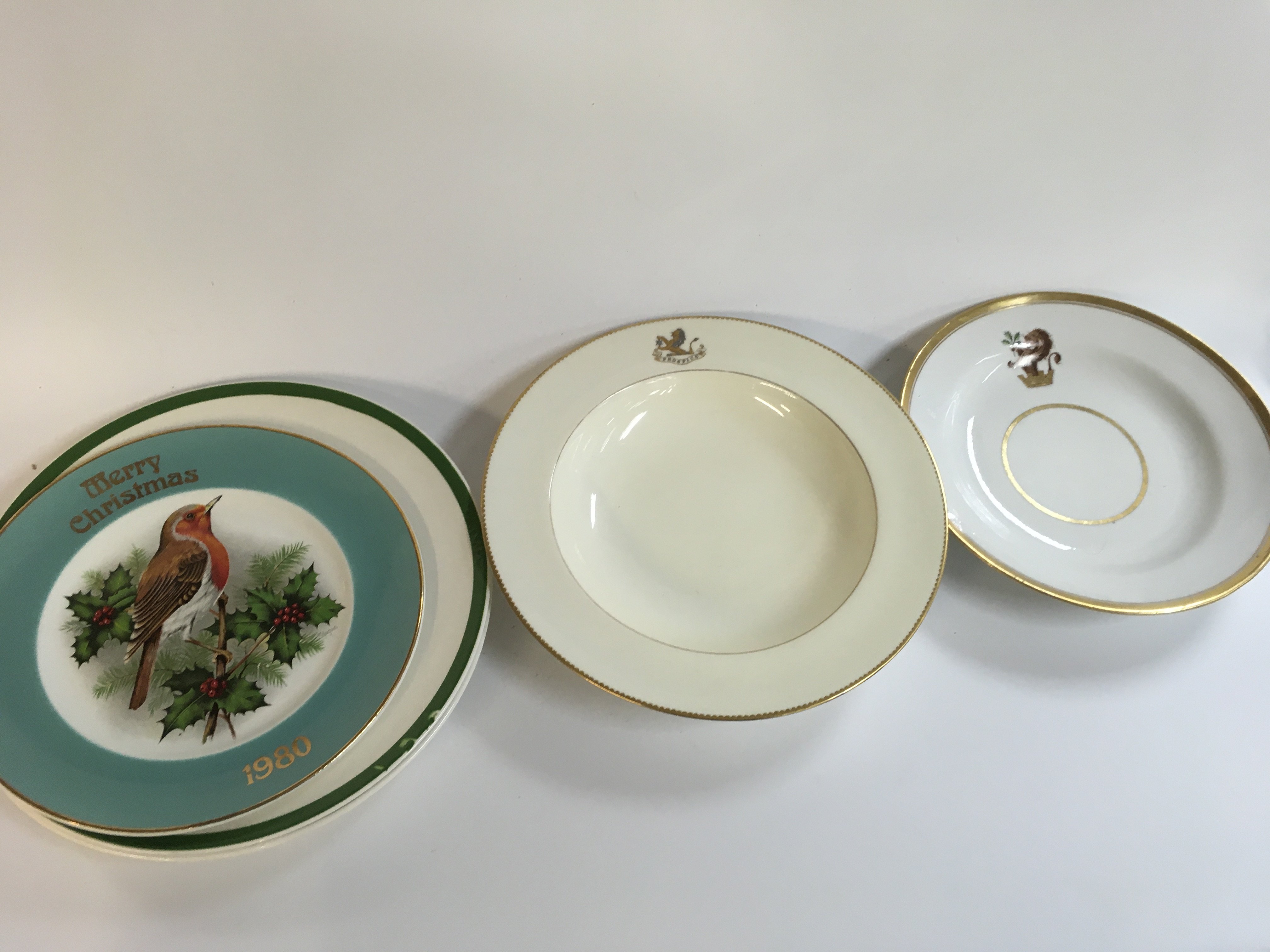 Christmas plates and two antique Minton 1885 armorial plates with lion . No reserve