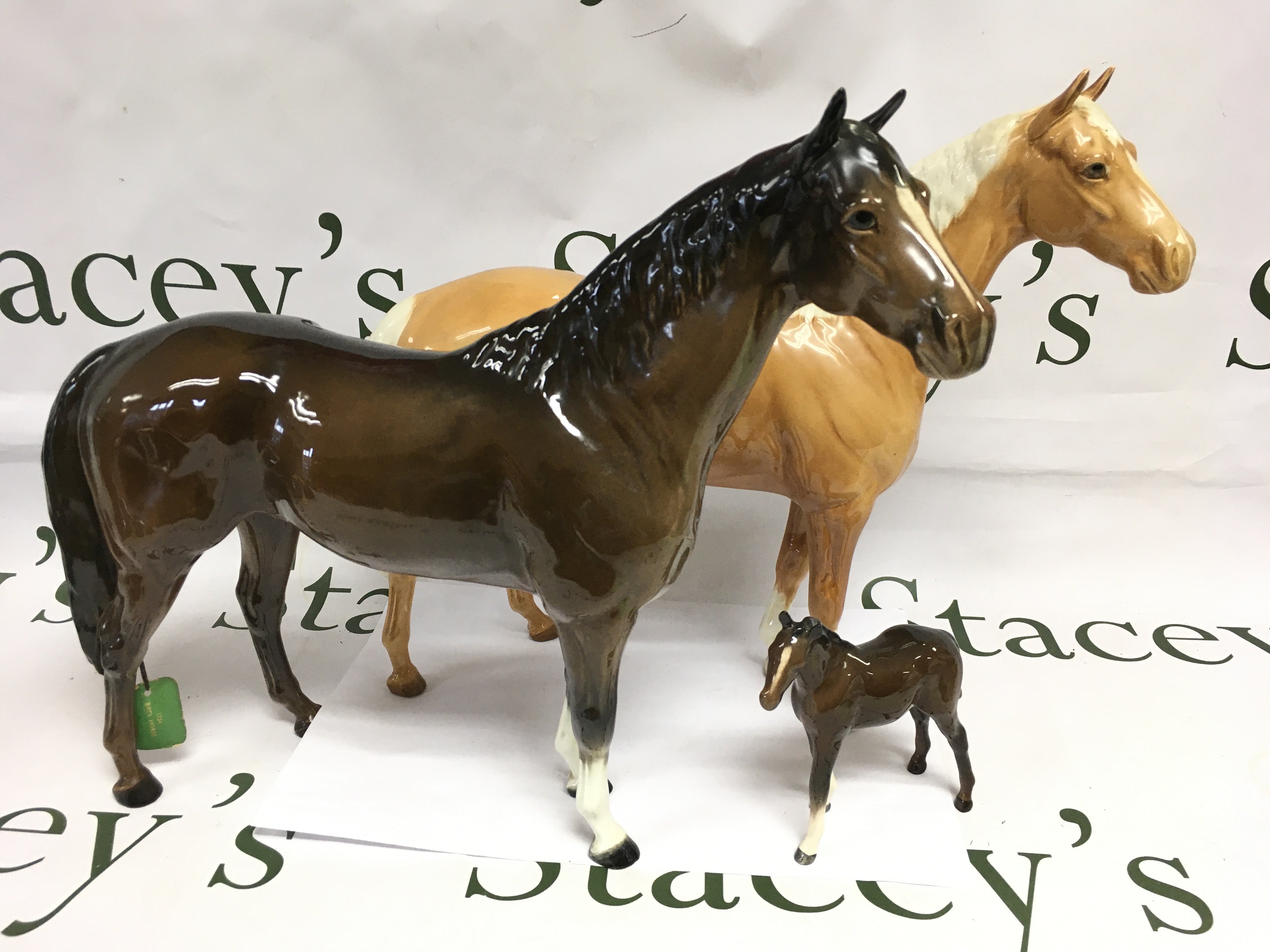 Three Beswick horses comprising two large and one small example, largest heigh approx 30.5cm. Shipping category D.