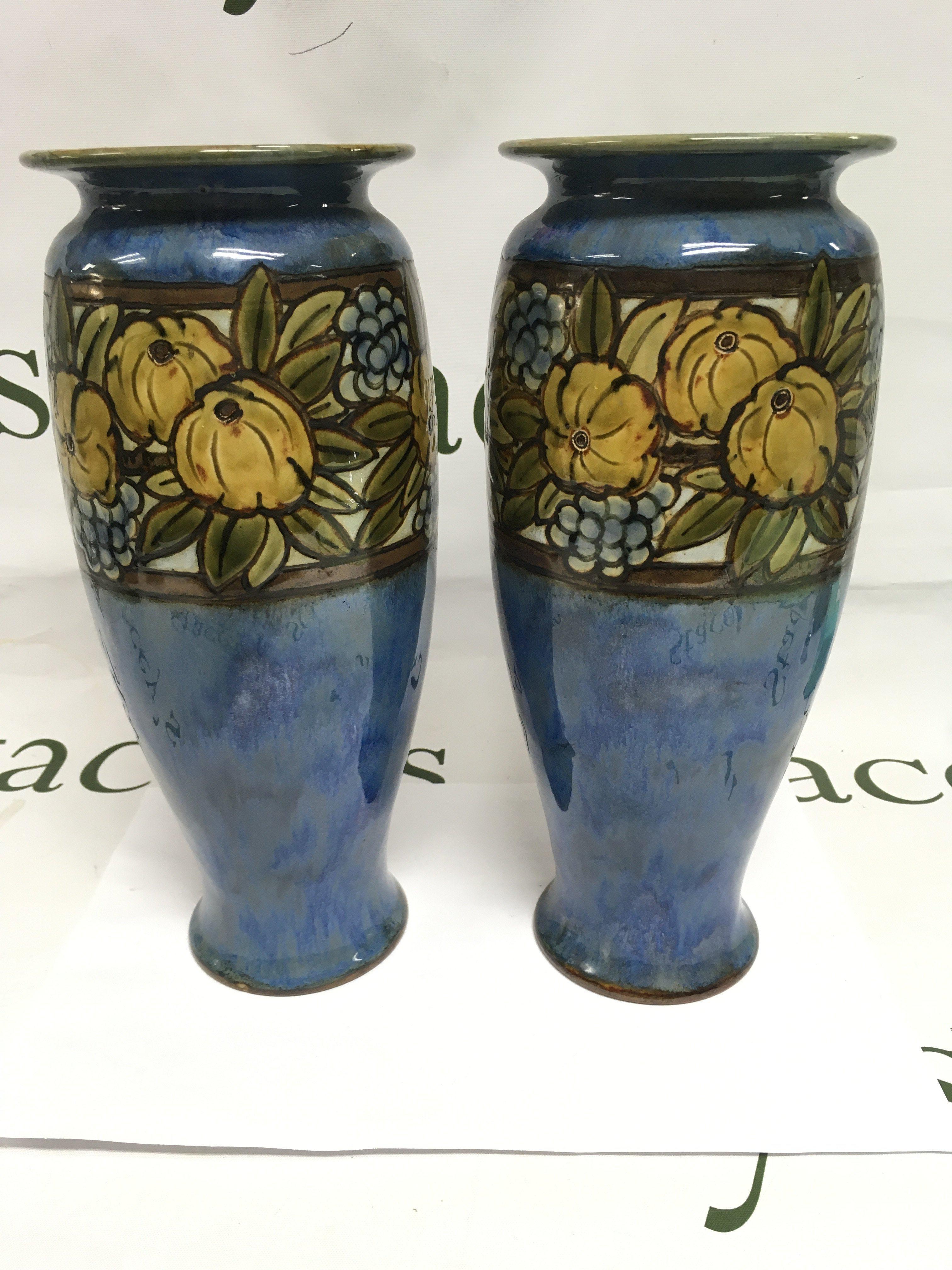 A pair of Royal Doulton vases with banded floral decoration, approx height 27cm. Shipping category D.