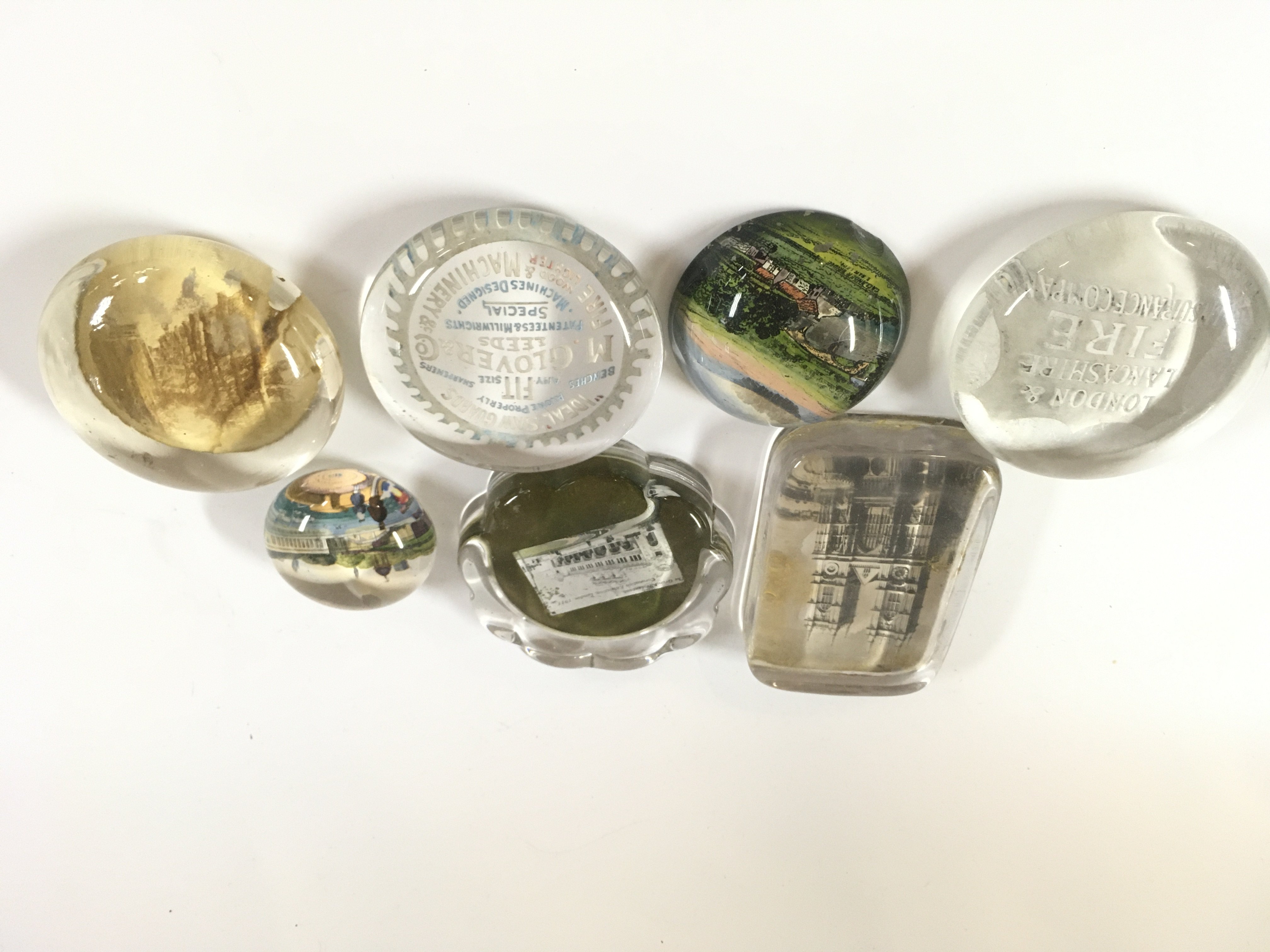 A lot of seven mixed paperweights.