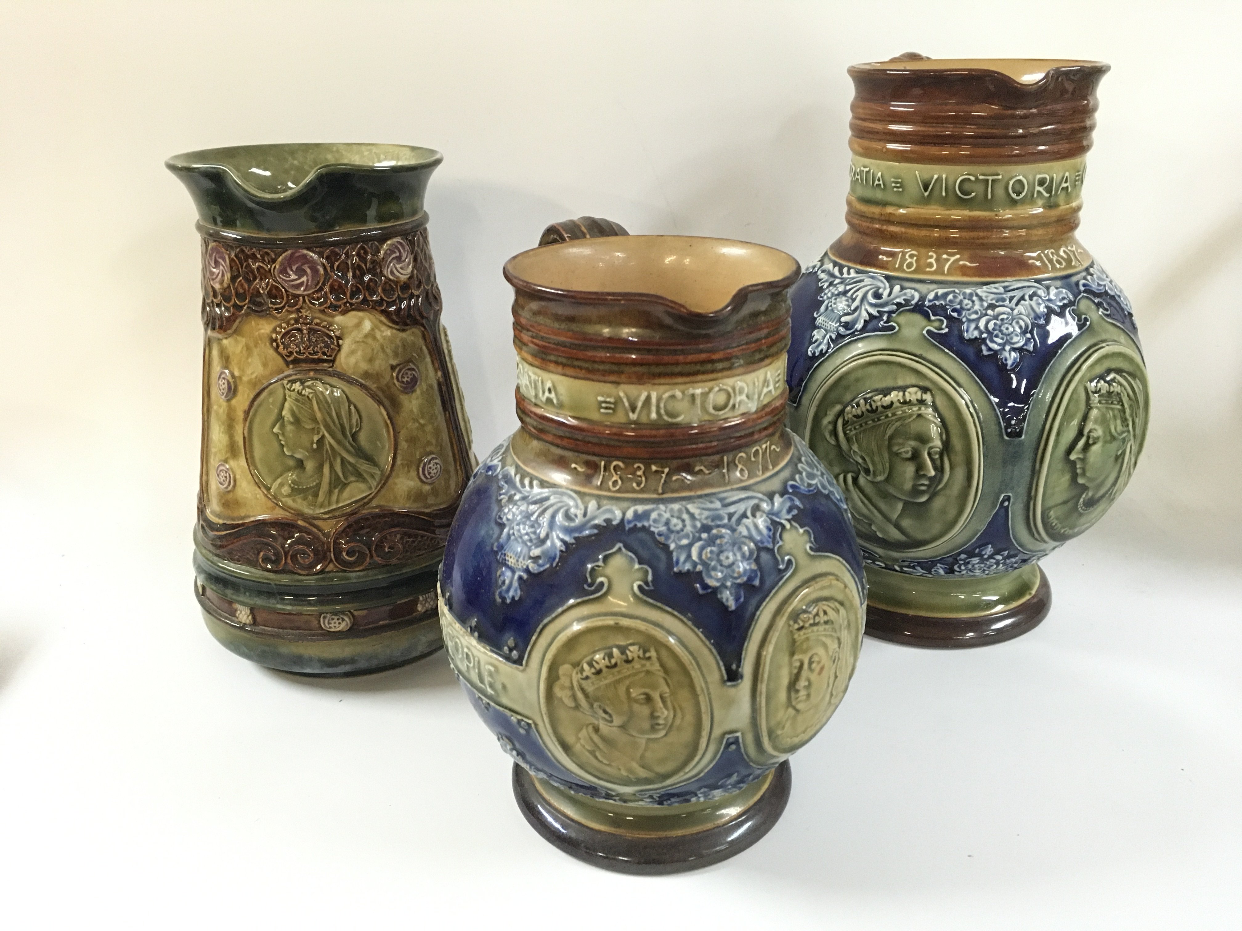 Three Queen Victoria royal Doulton jugs.