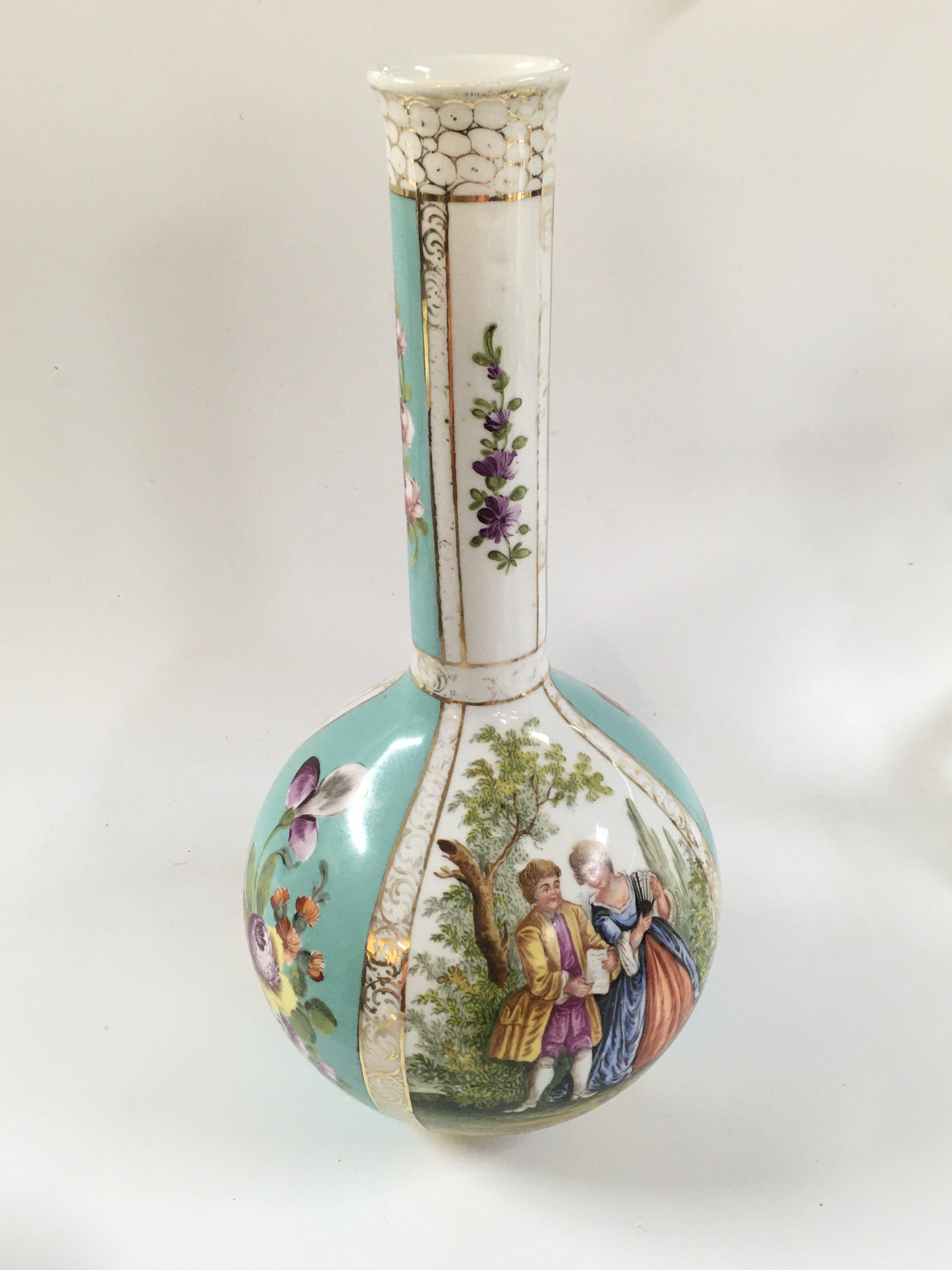 A Dresden bottle vase with floral patterns and gold features. Approx height 32 cm.