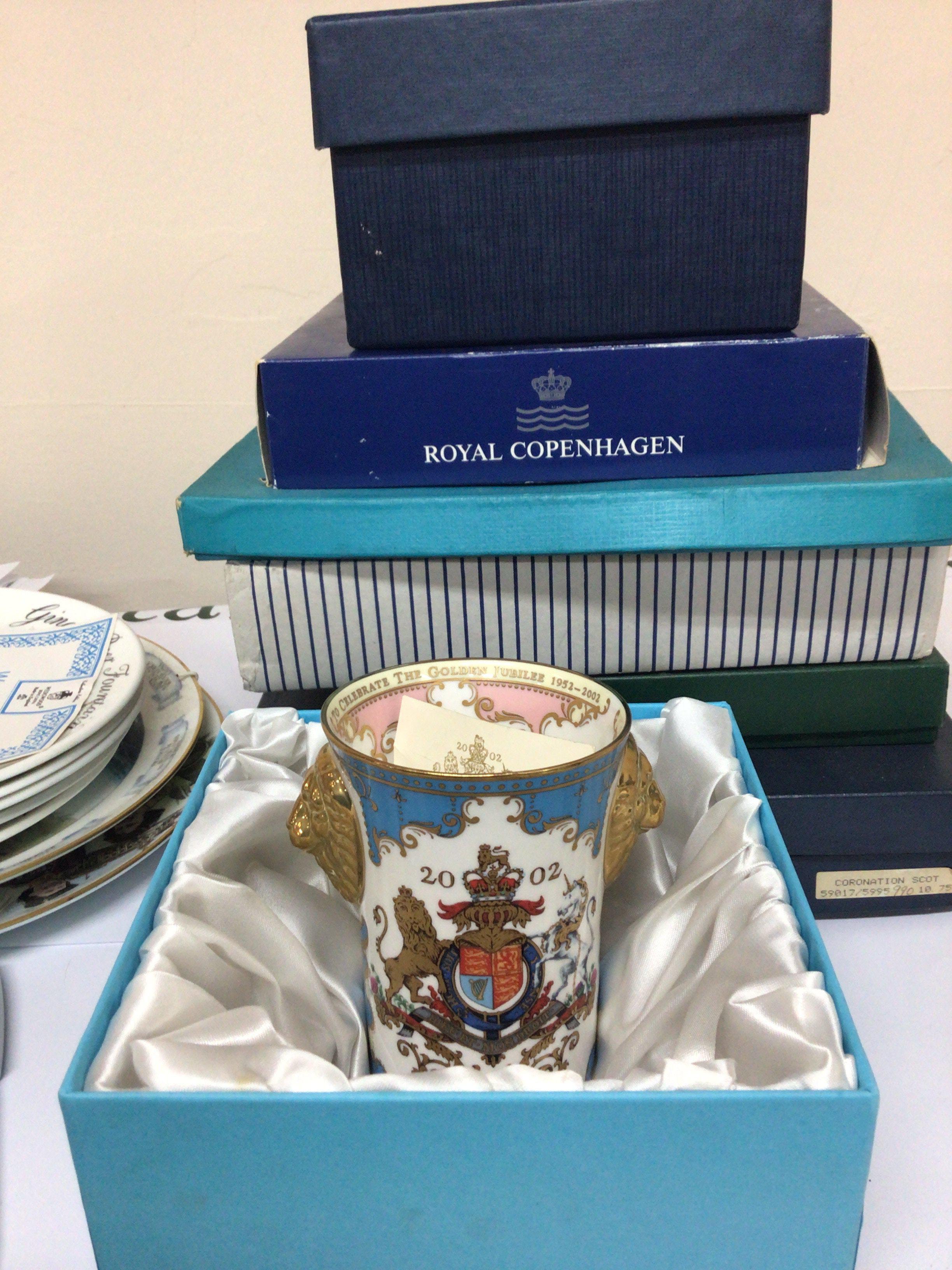 A box containing Boxed Royal Copenhagen collectors plates Buckingham Palace limited edition Beaker 2002 in a fitted box Wedgwood collectors plates and loose unboxed plates