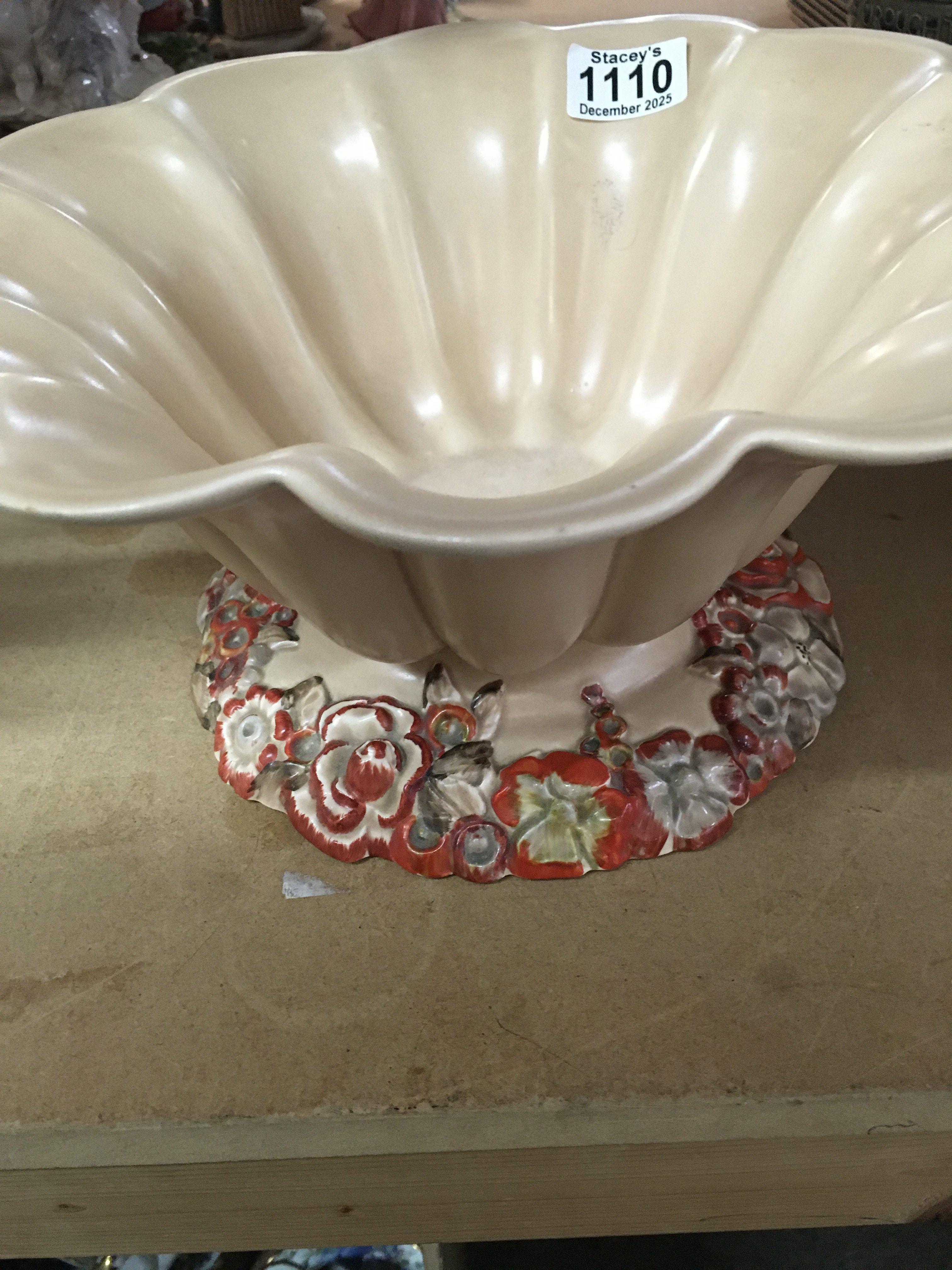 A Clarice Cliff bowl of floral design the base with raised flower heads .