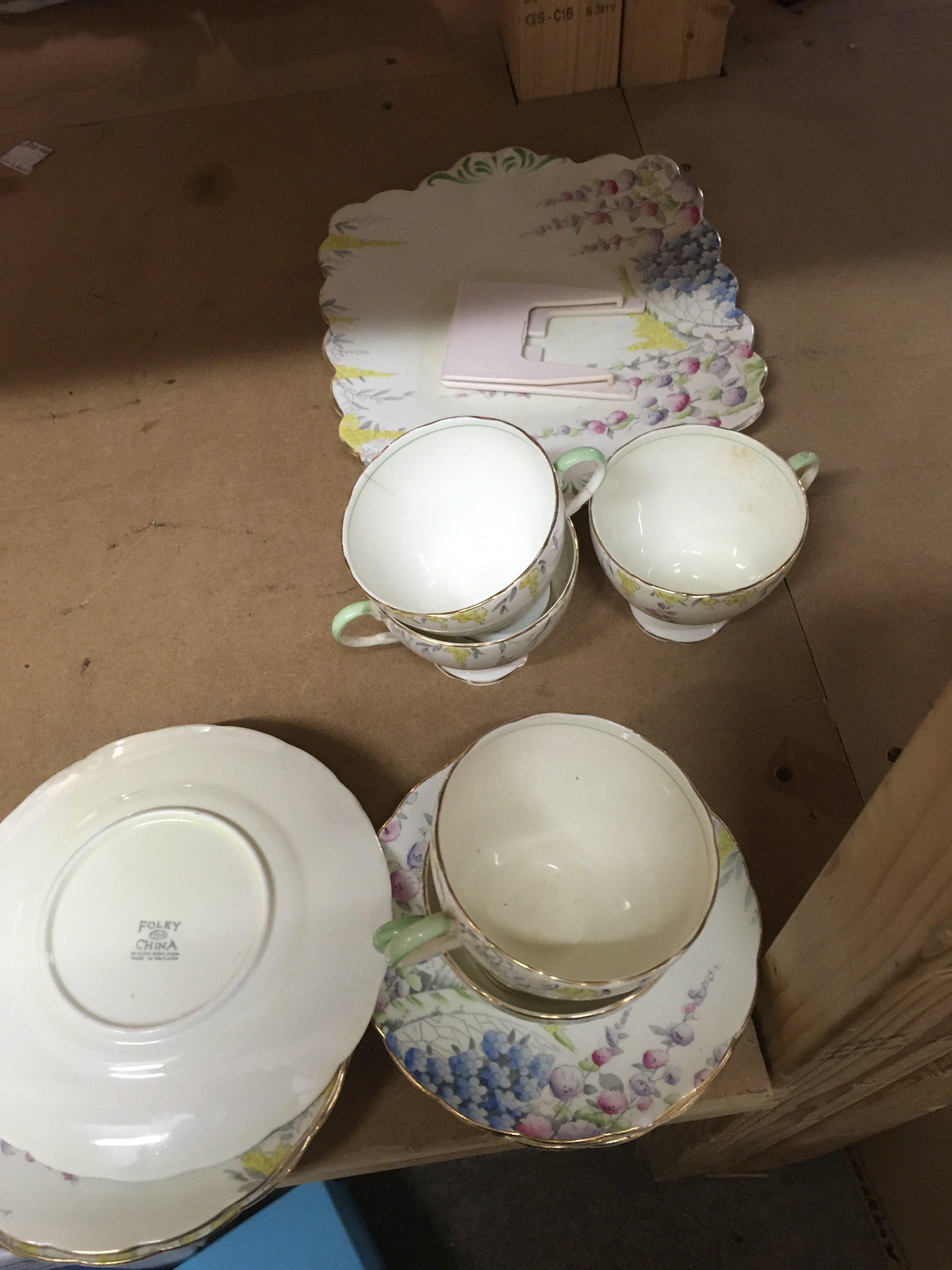 A part Foley tea set decorated with flowers and foliage.