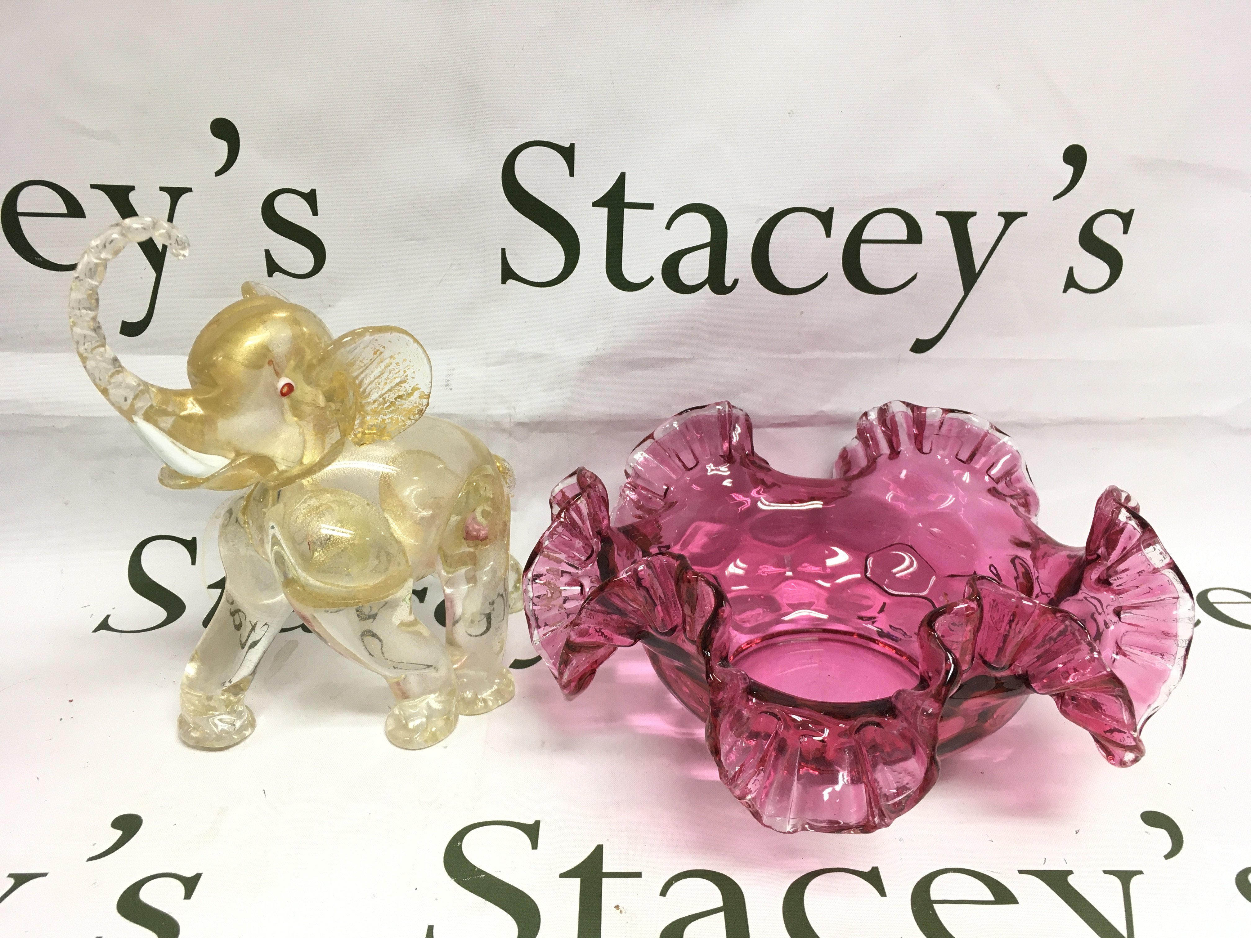 A Murano glass figure of an elephant and a cranberry glass dish (2). Shipping category D.