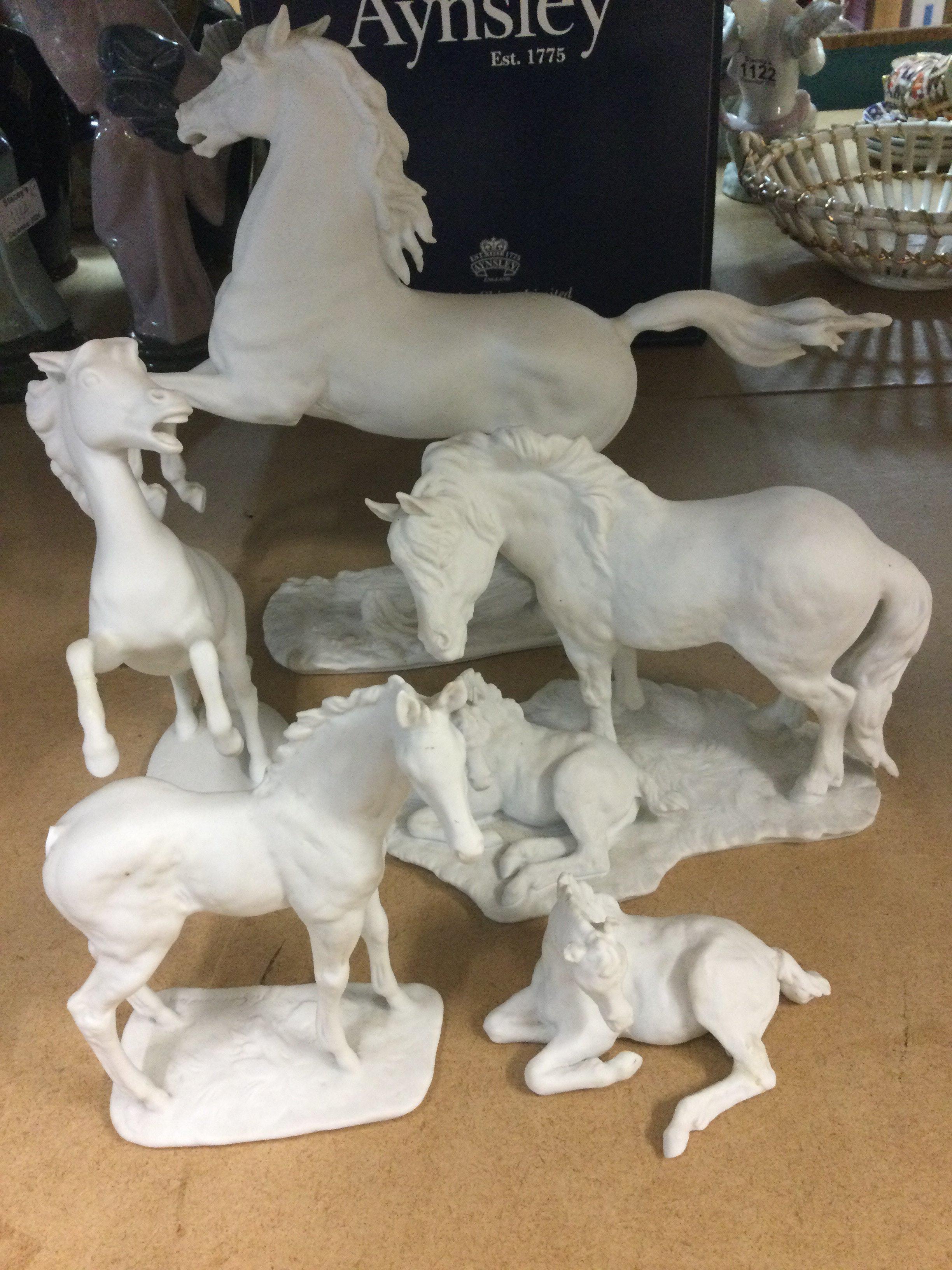 A collection of five Kaiser white glazed porcelain horse figures .