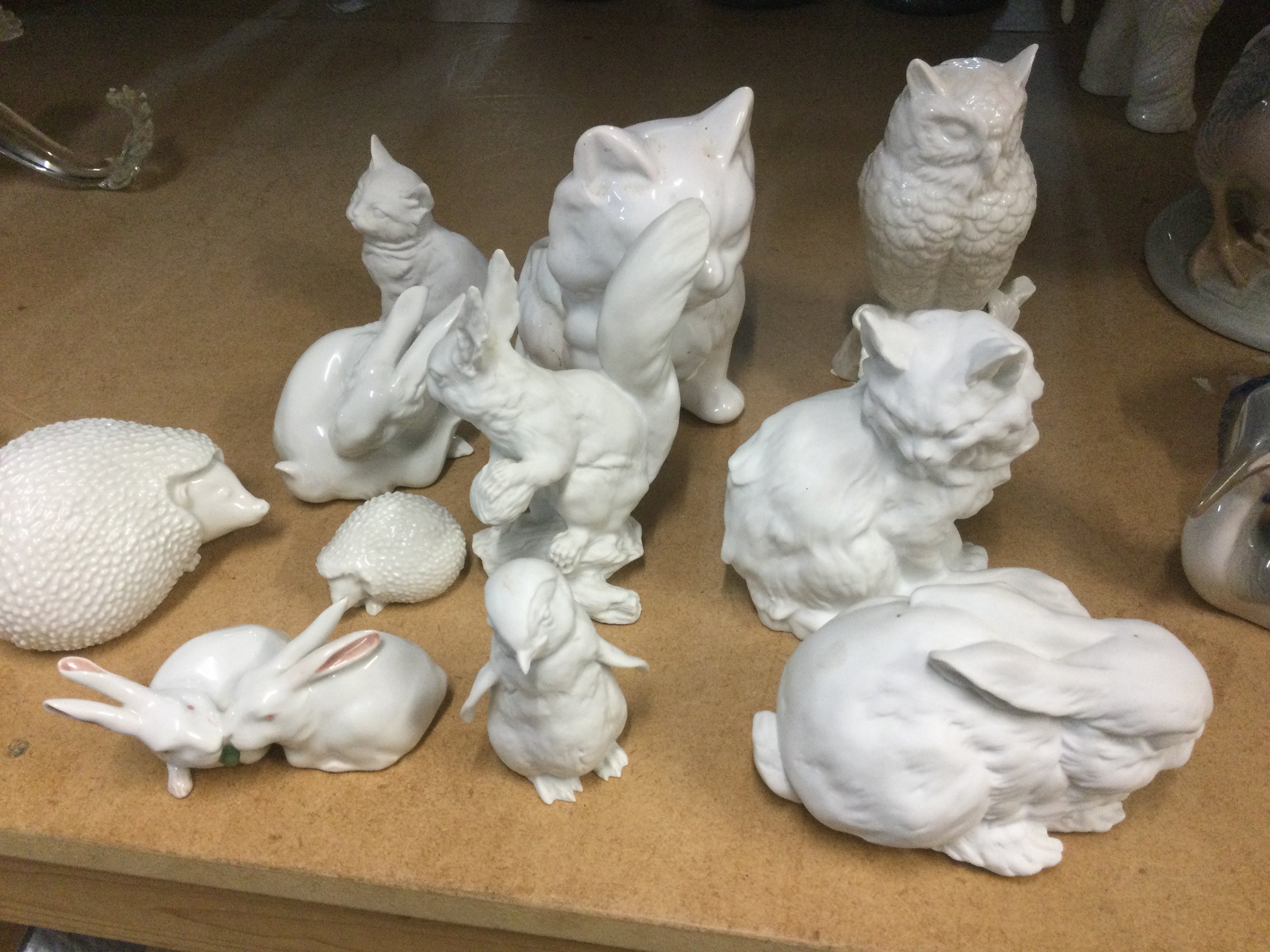 A collection of white glazed animal figures including Copenhagen.