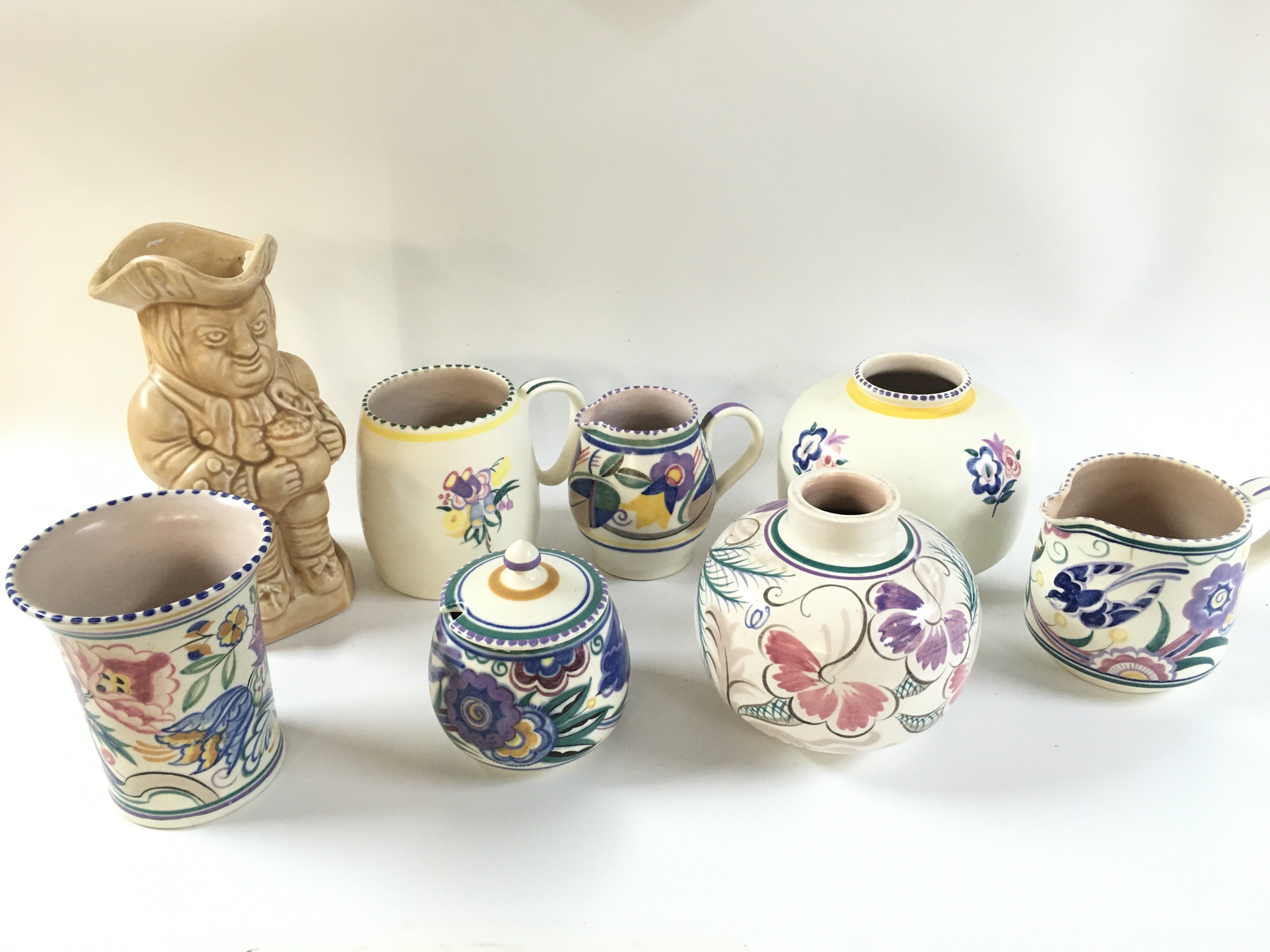 Poole pottery vases and jugs and an Arthur Wood toby jug . This lot cannot be posted