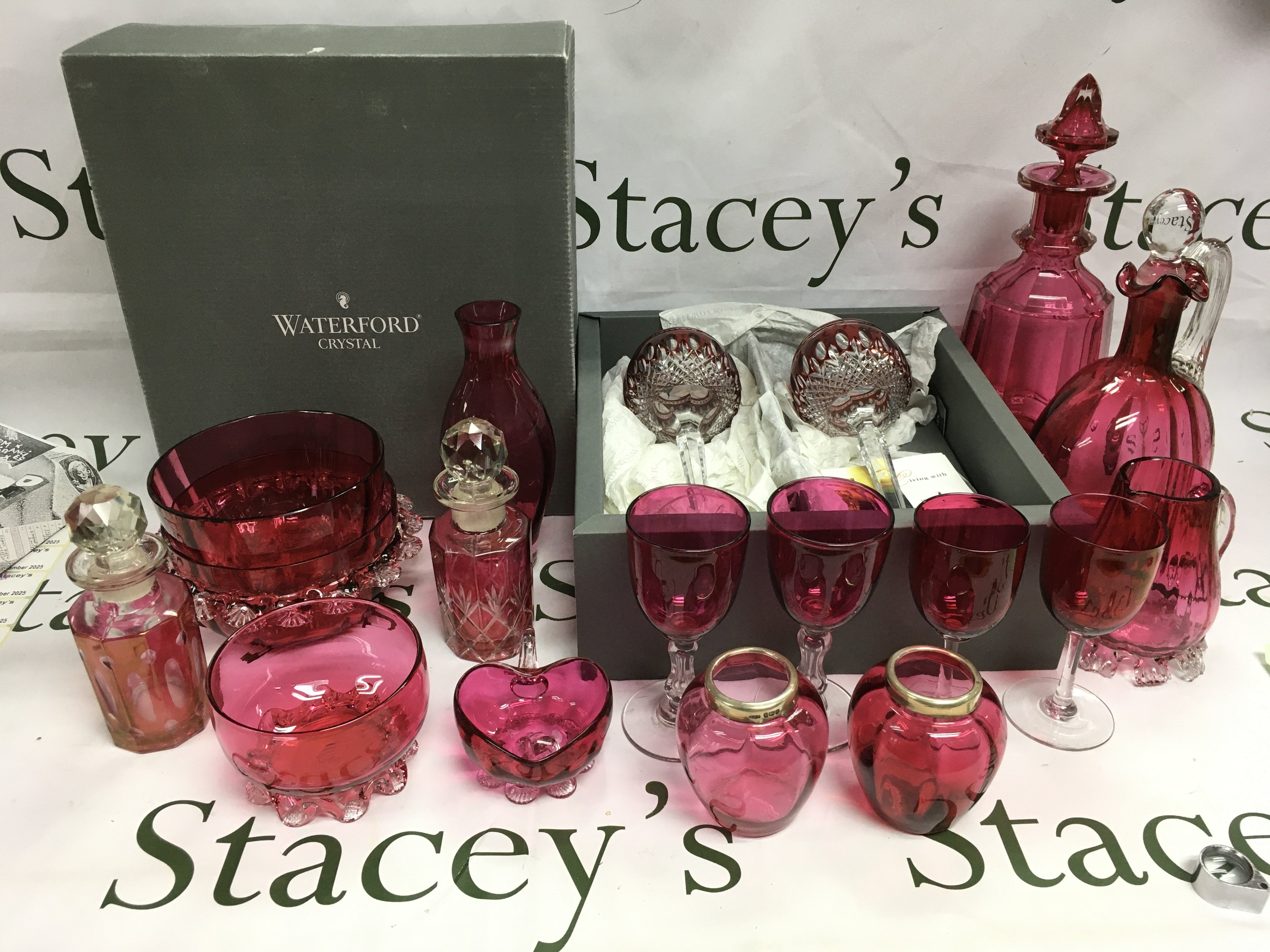A collection of glassware comprising mainly cranberry examples, a boxed pair of Waterford Crystal drinking glasses etc. Shipping category D.