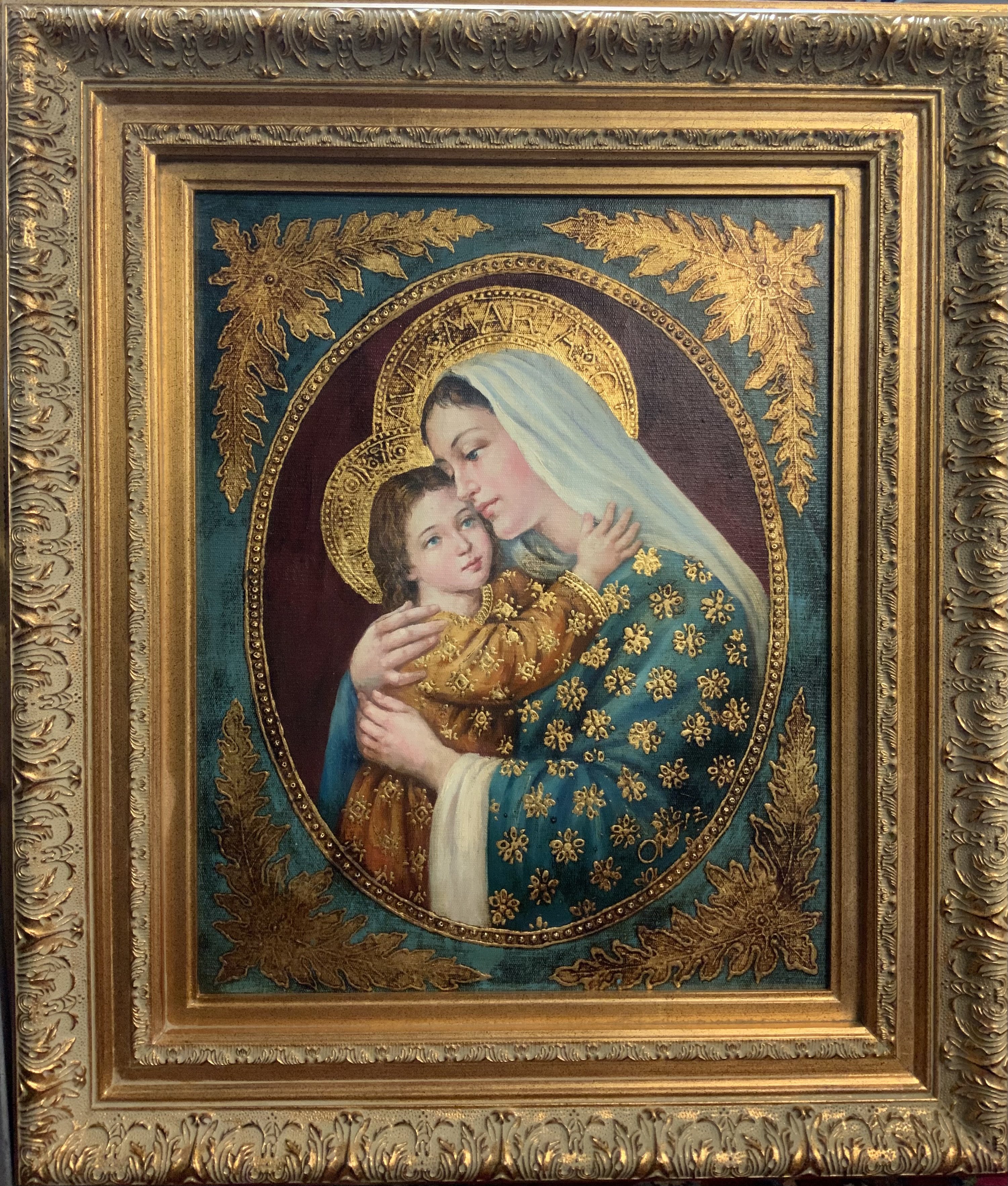 A gilt framed oil on canvas oil on canvas acting of Madonna and child . 74cm x 63cm