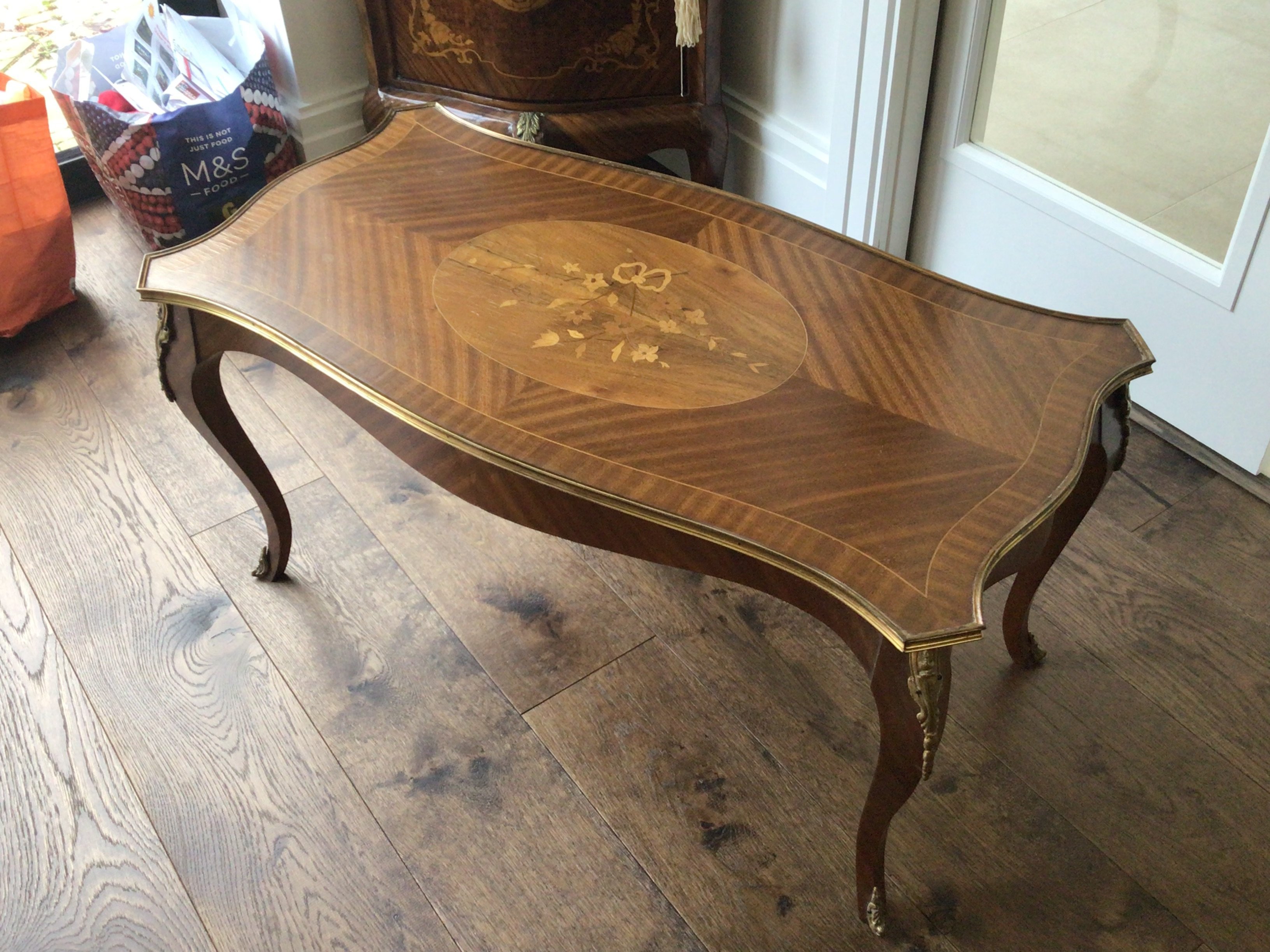 A French Louis XV style coffee table with gilt metal mounts