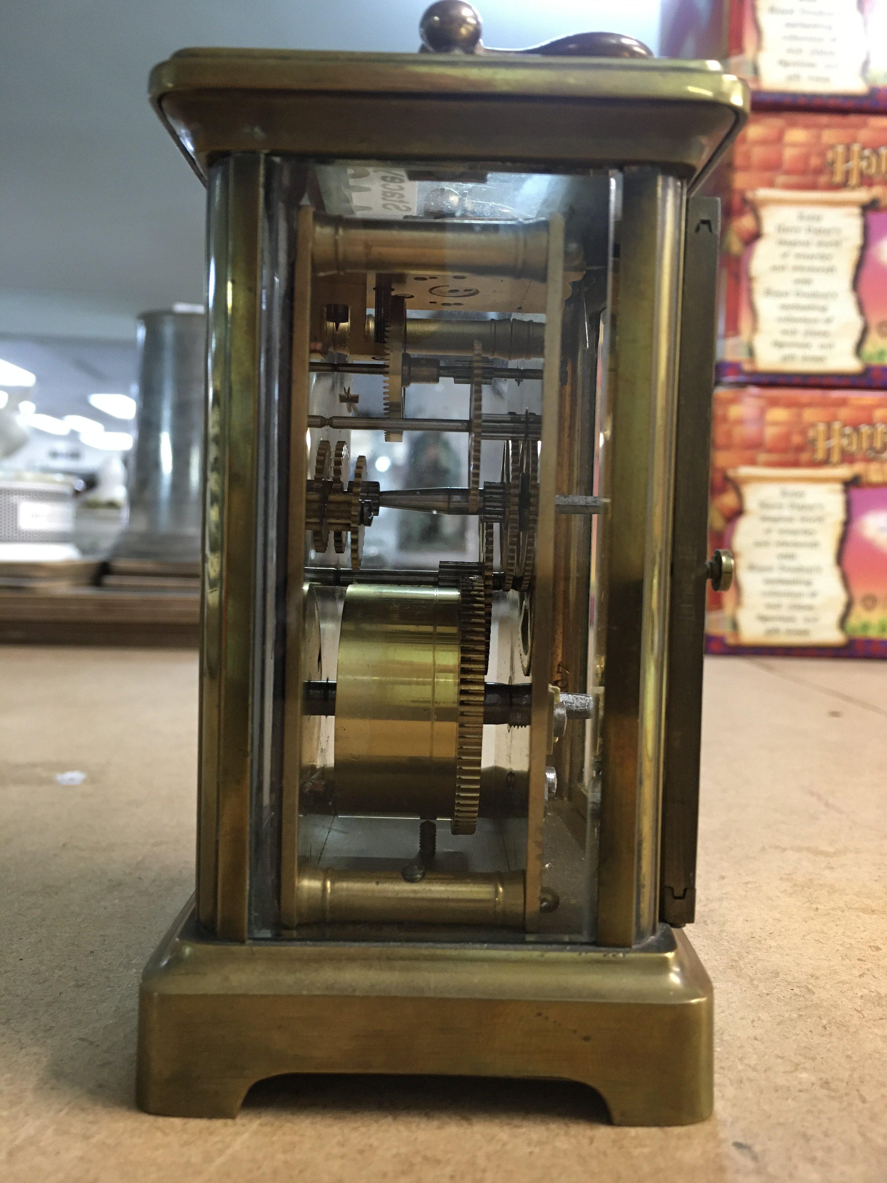 A brass case carriage clock, the enamel dial with Roman numerals- NO RESERVE