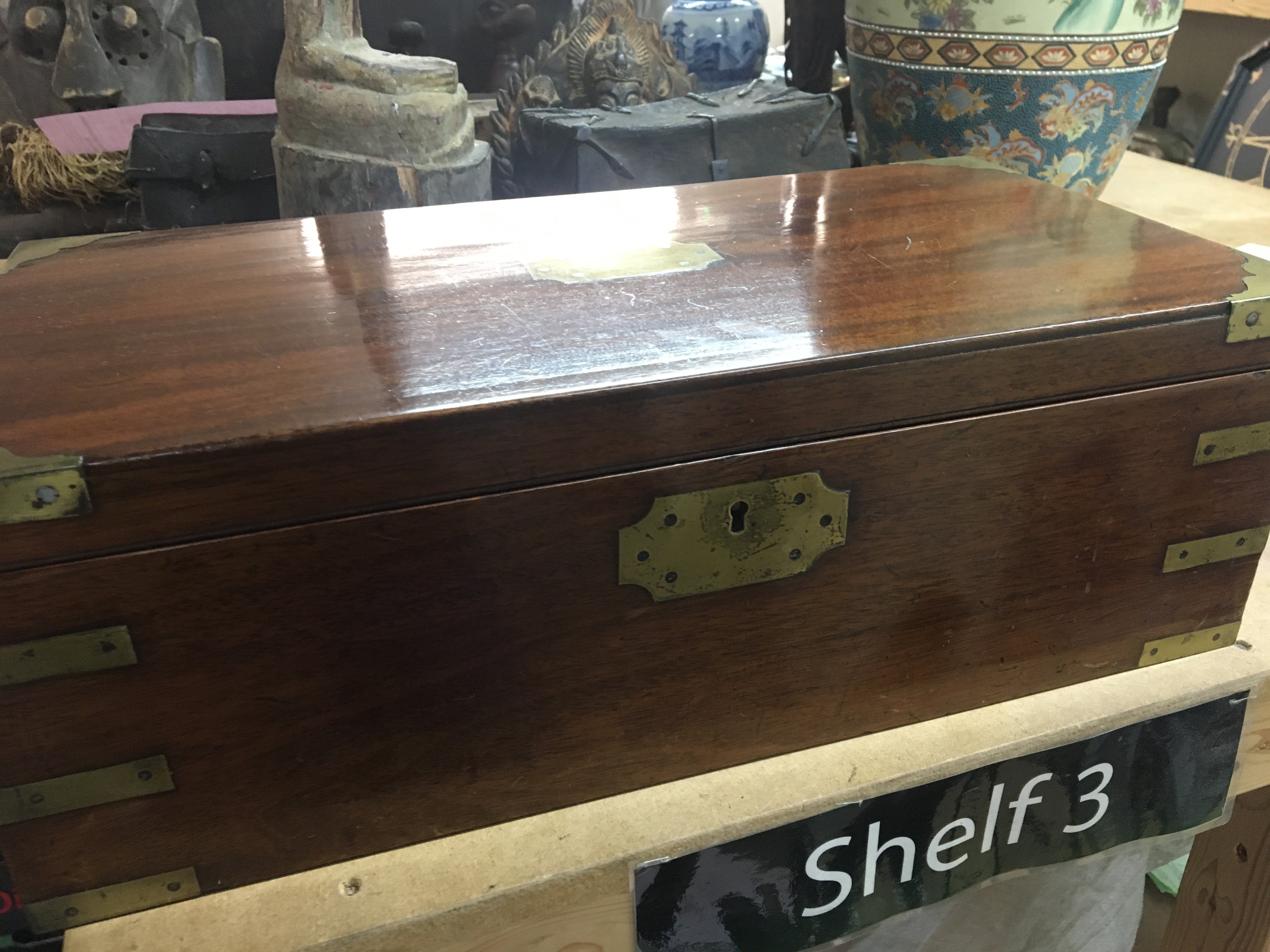 A Mahogany campaign writing slope brass bound with a fitted interior.- NO RESERVE