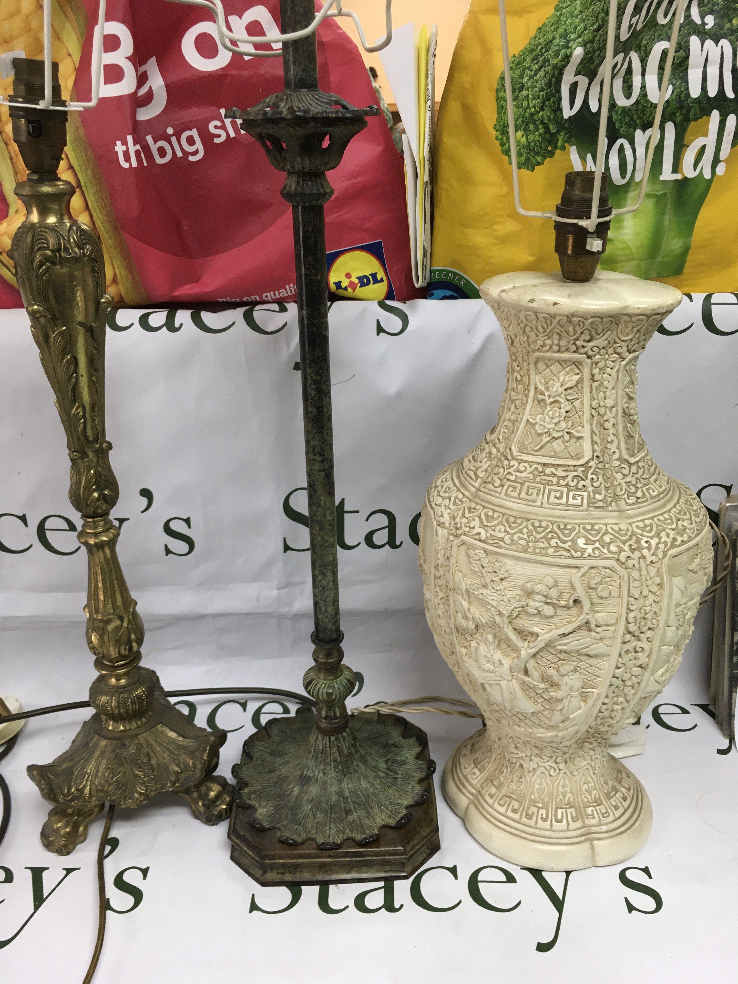 Three table lamps comprising a gilded example and two others. Shipping category D.