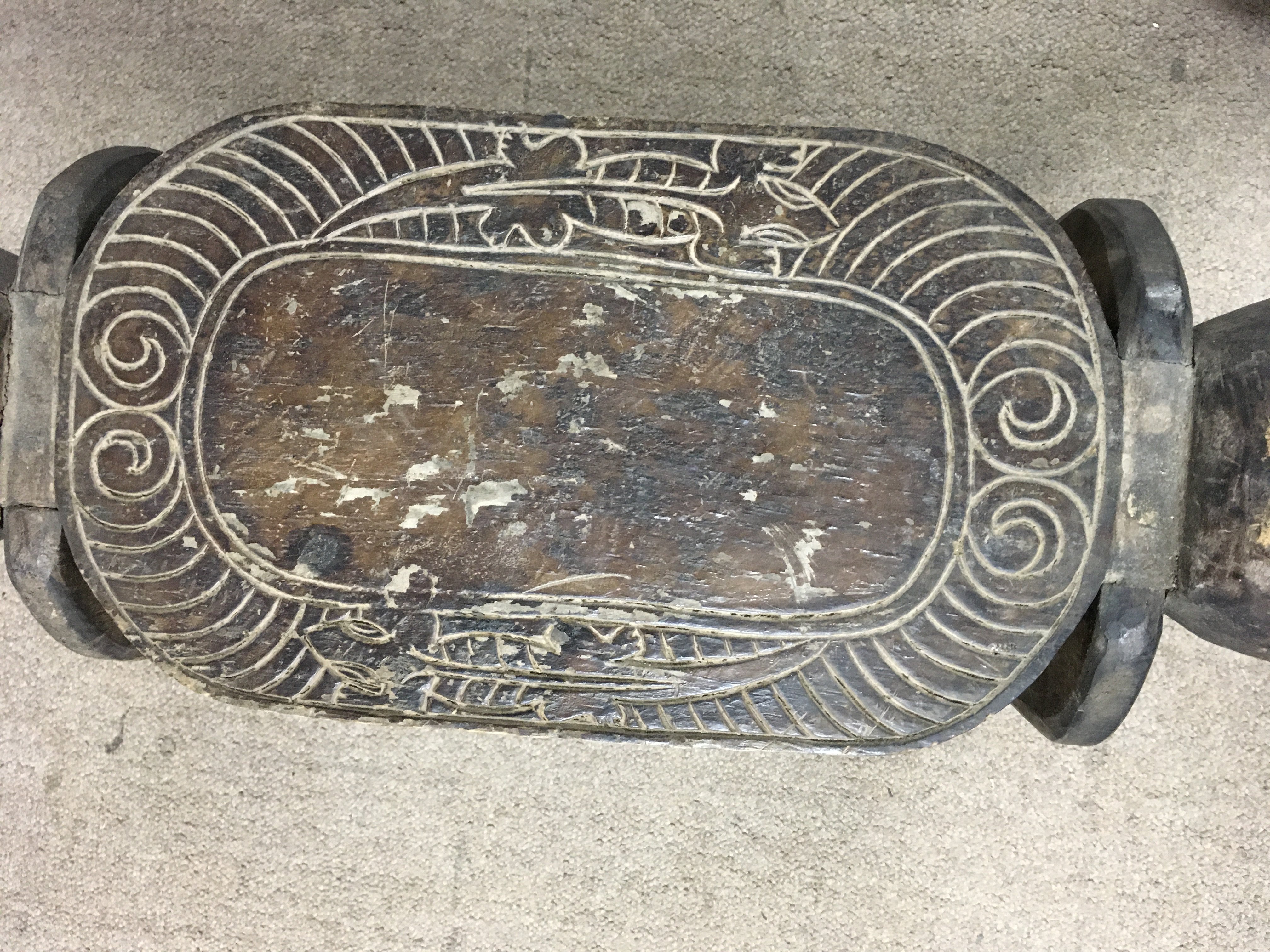 A hand carved African stool. Length 90cm, height 43cm.- NO RESERVE