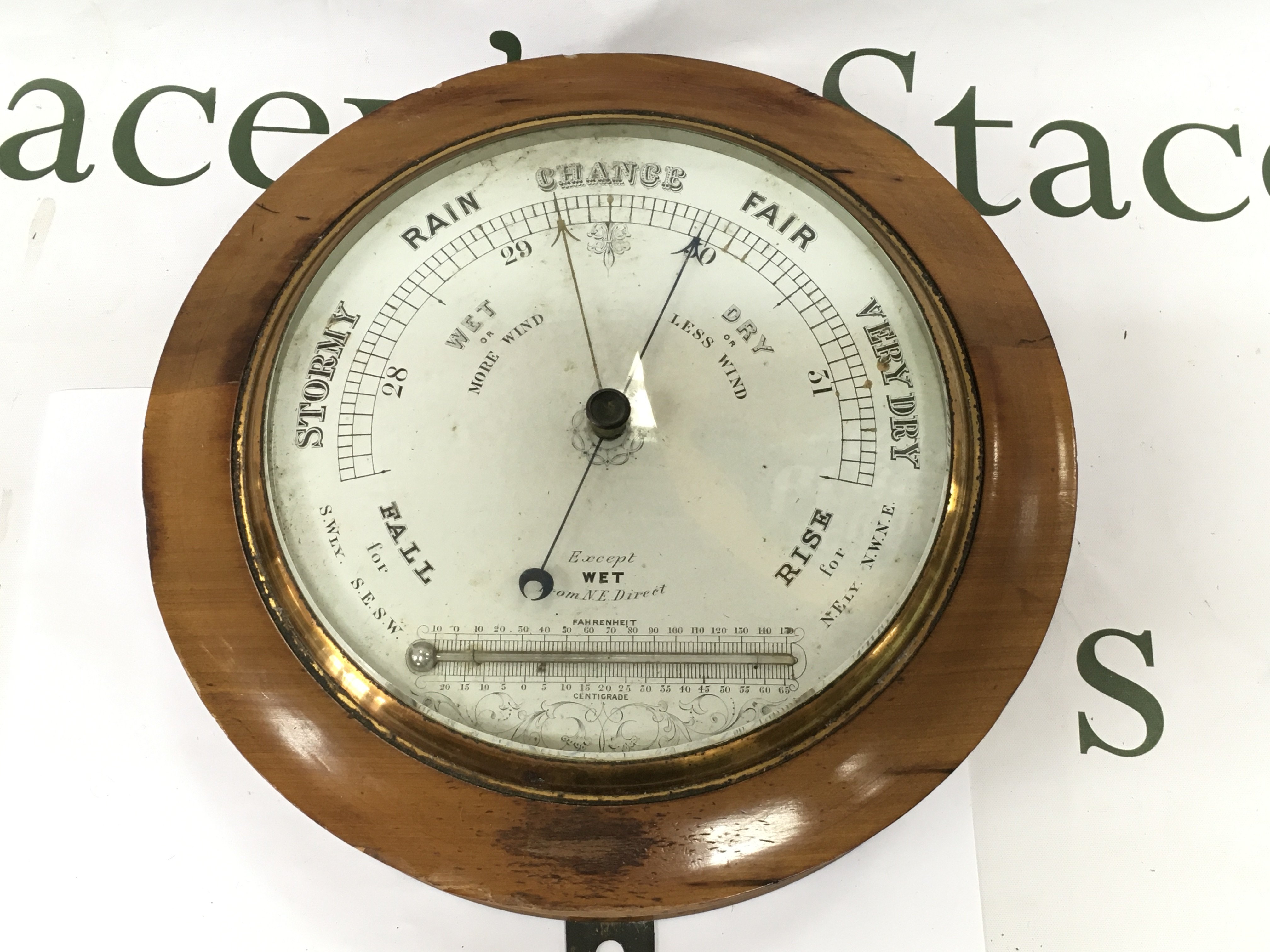 A circular wall barometer. Shipping category D.