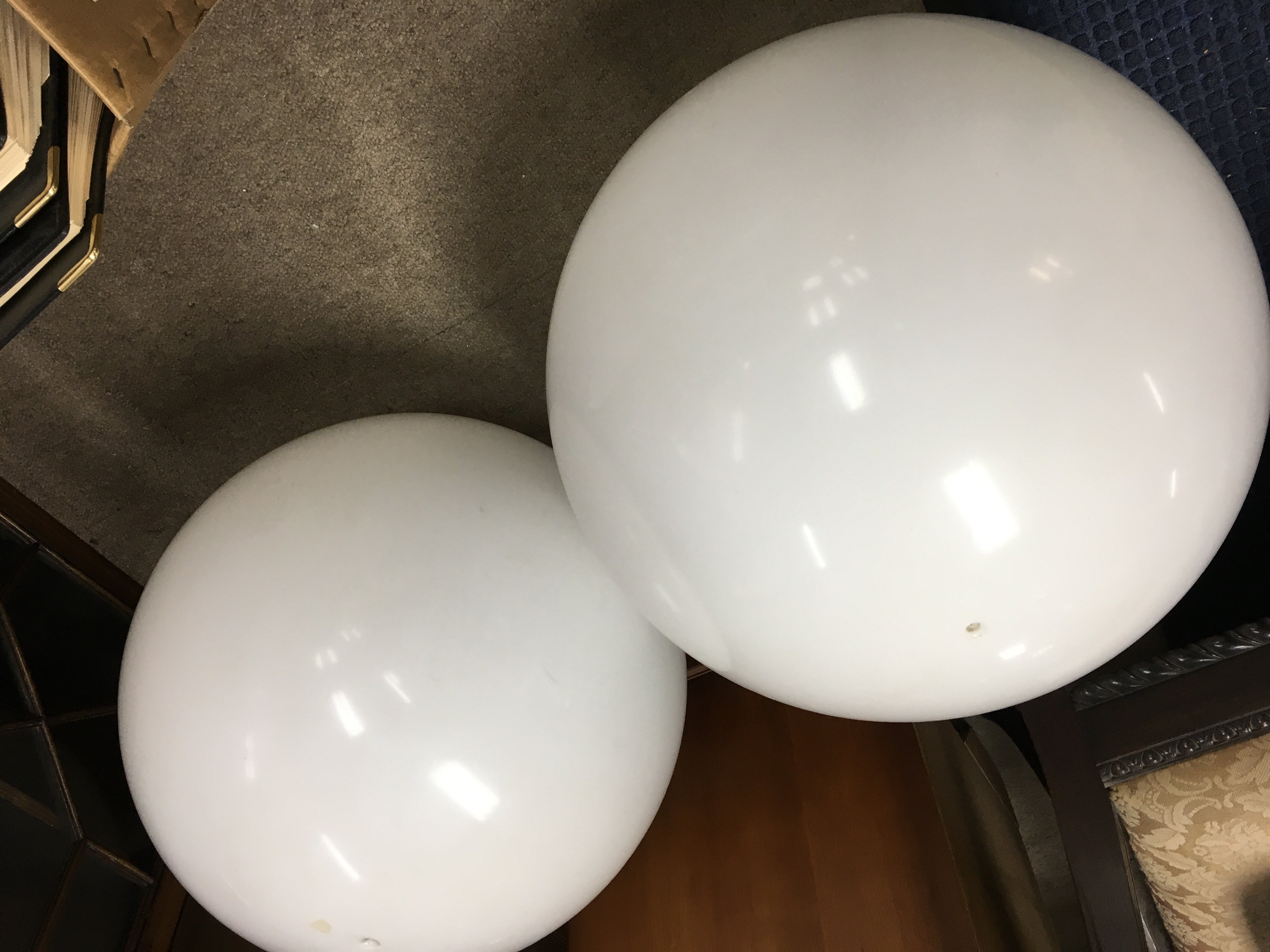 William Suggest globe lights with cast iron brackets.