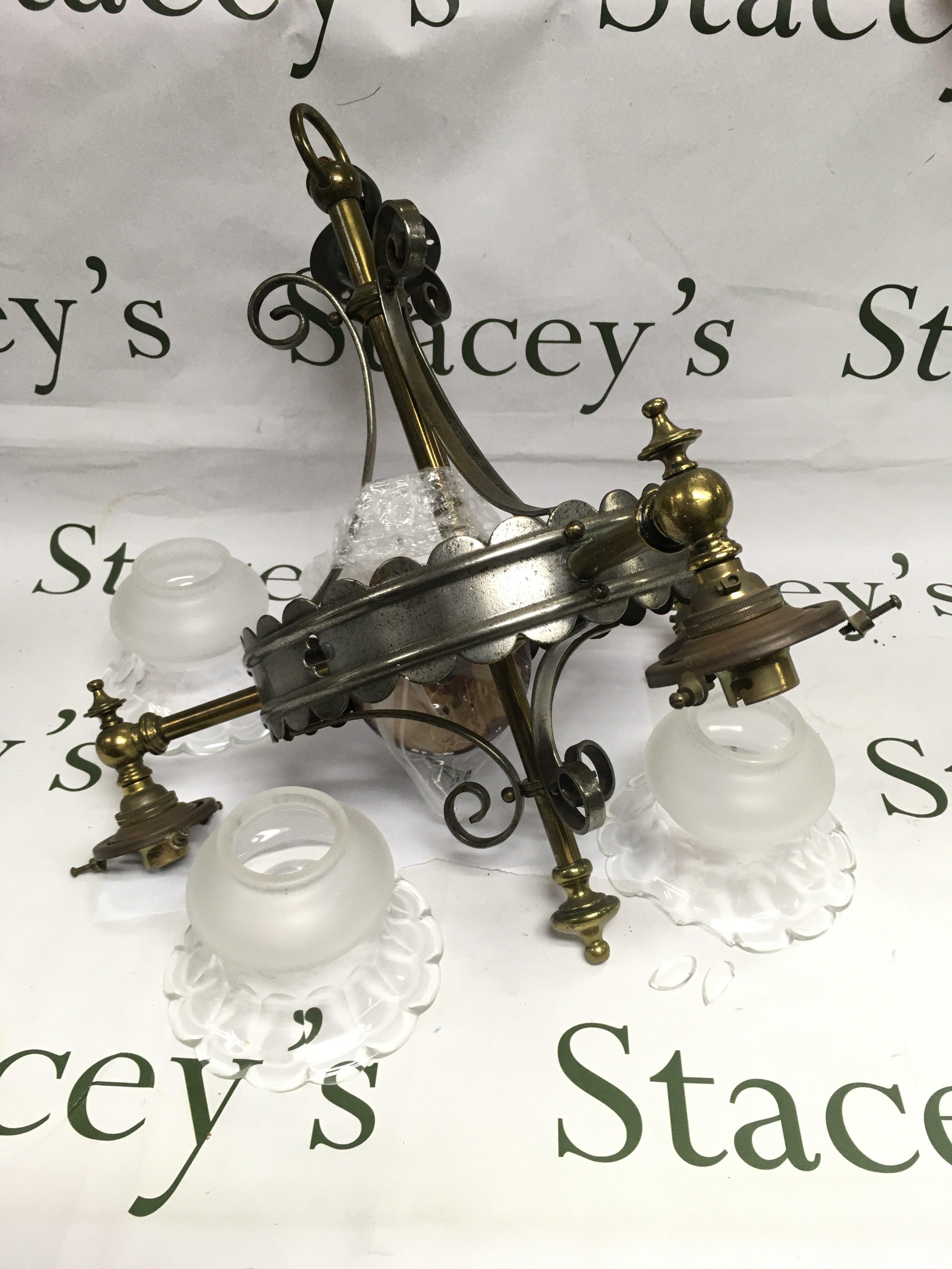 A three branch steel and brass ceiling lamp, approx height 44cm. Damage to one shade. Shipping category D.