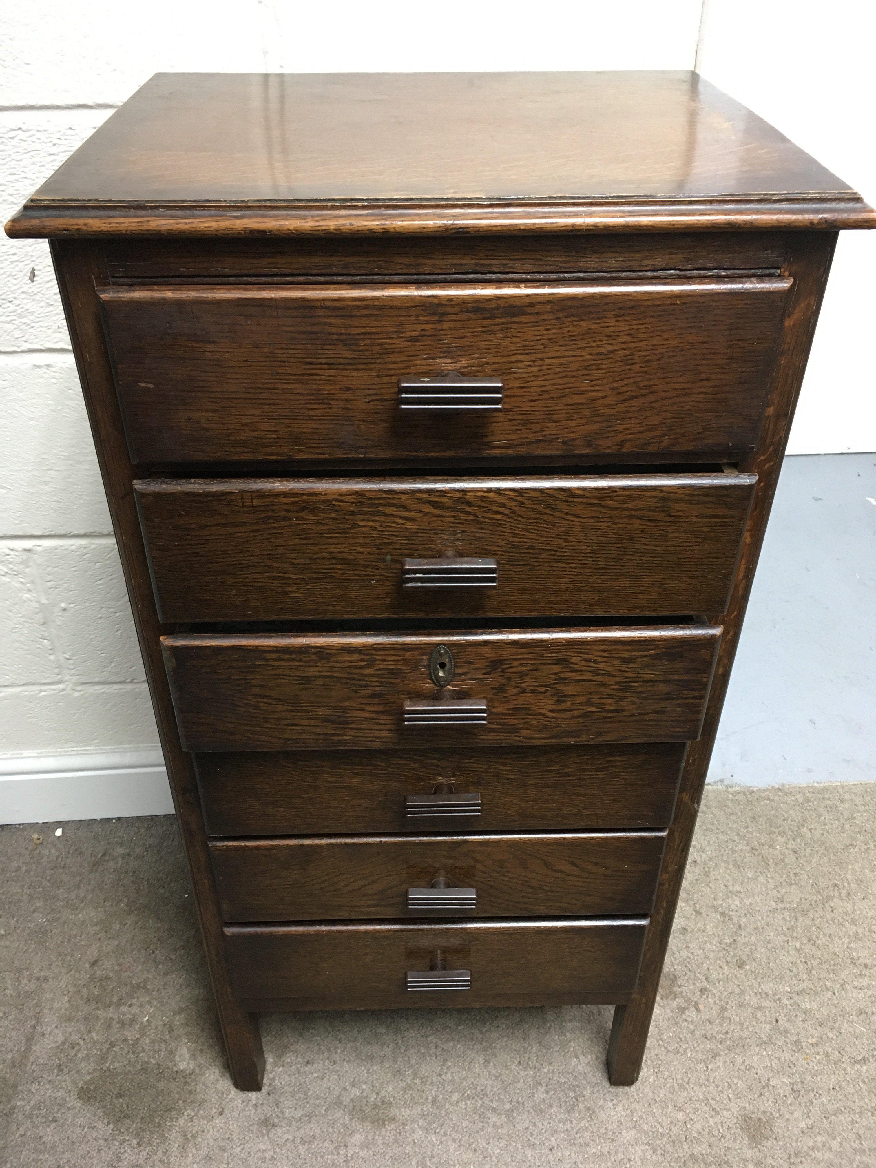 A tall oak flight of drawers. Approx height 98cm