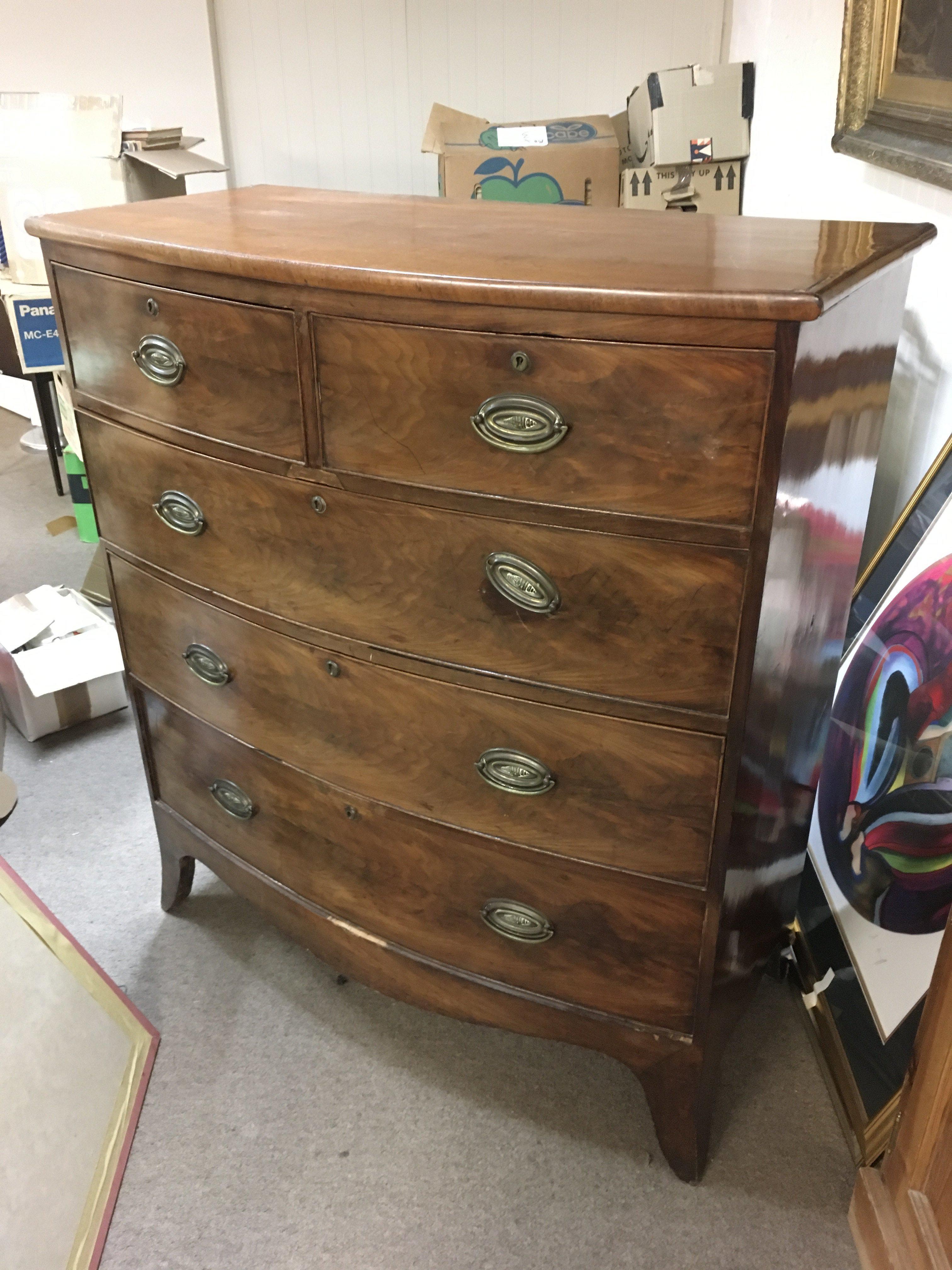A mahogany bow fronted chest of drawers fitted two short drawers over three long, approx 107cm x 52.5cm x 119cm. Shipping category D.