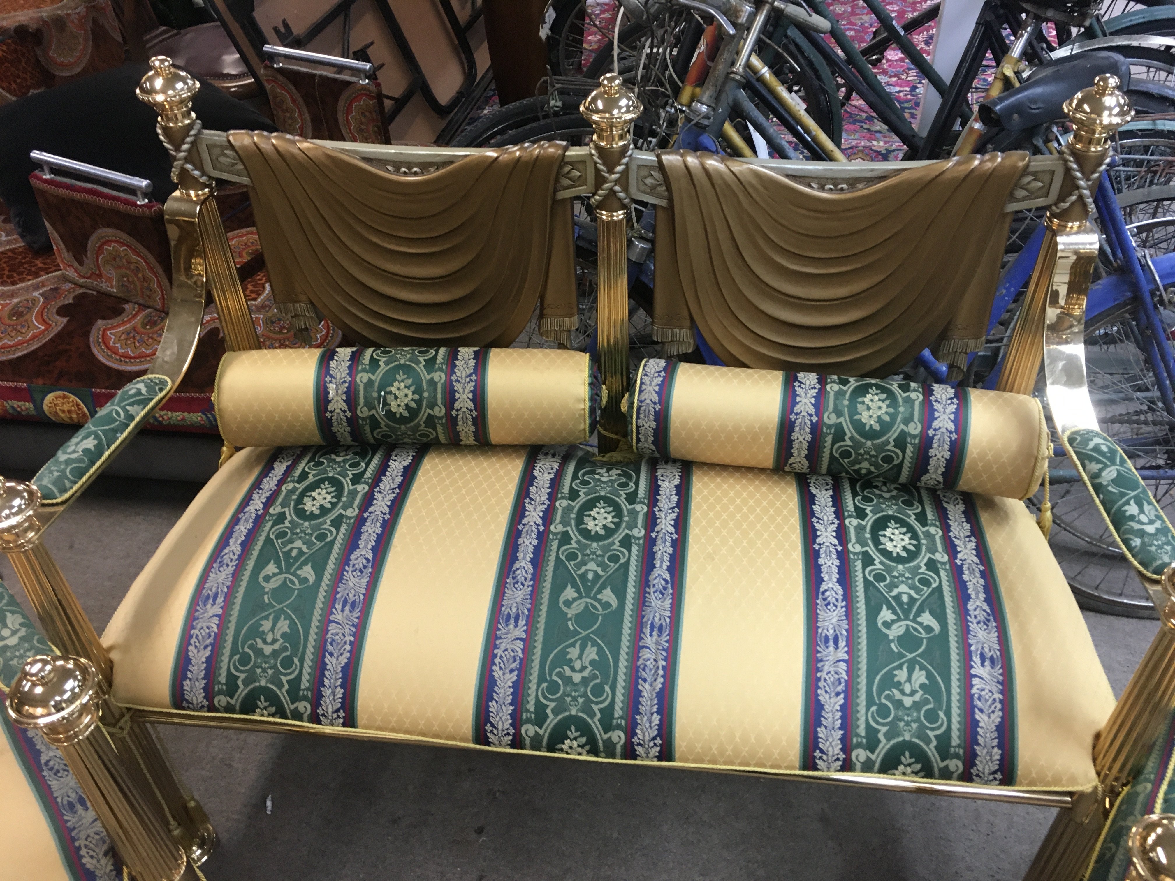 A pair of vintage Versace style gold-tone chairs with green and gold striped upholstery and a matching sofa. 98cm tall 70cm wide 50cm long